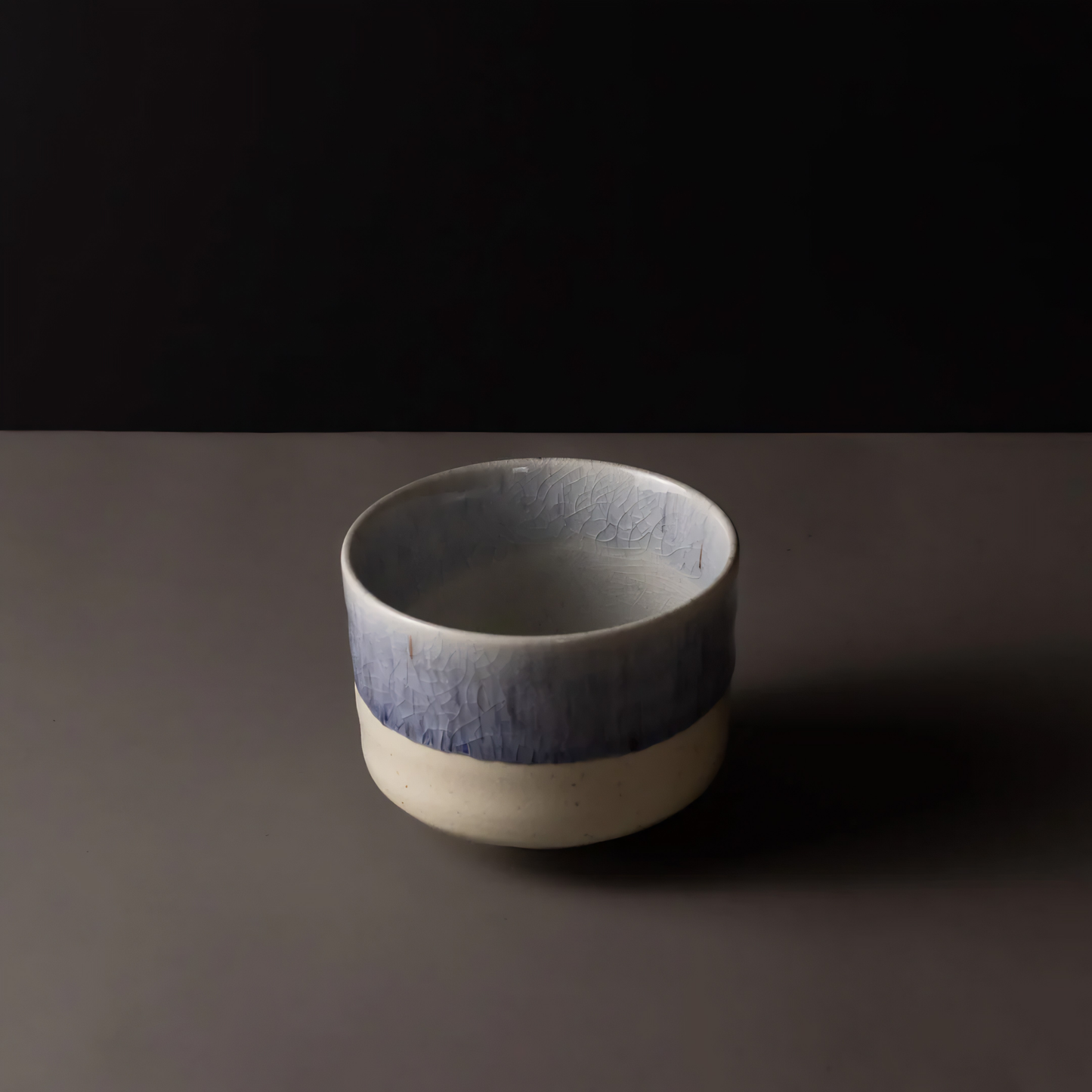 Semi top view of the Fathom Matcha Tea Bowl 10cm Winter Drift featuring a soft indigo glaze and a delicate speckled texture subtle crackle finish.