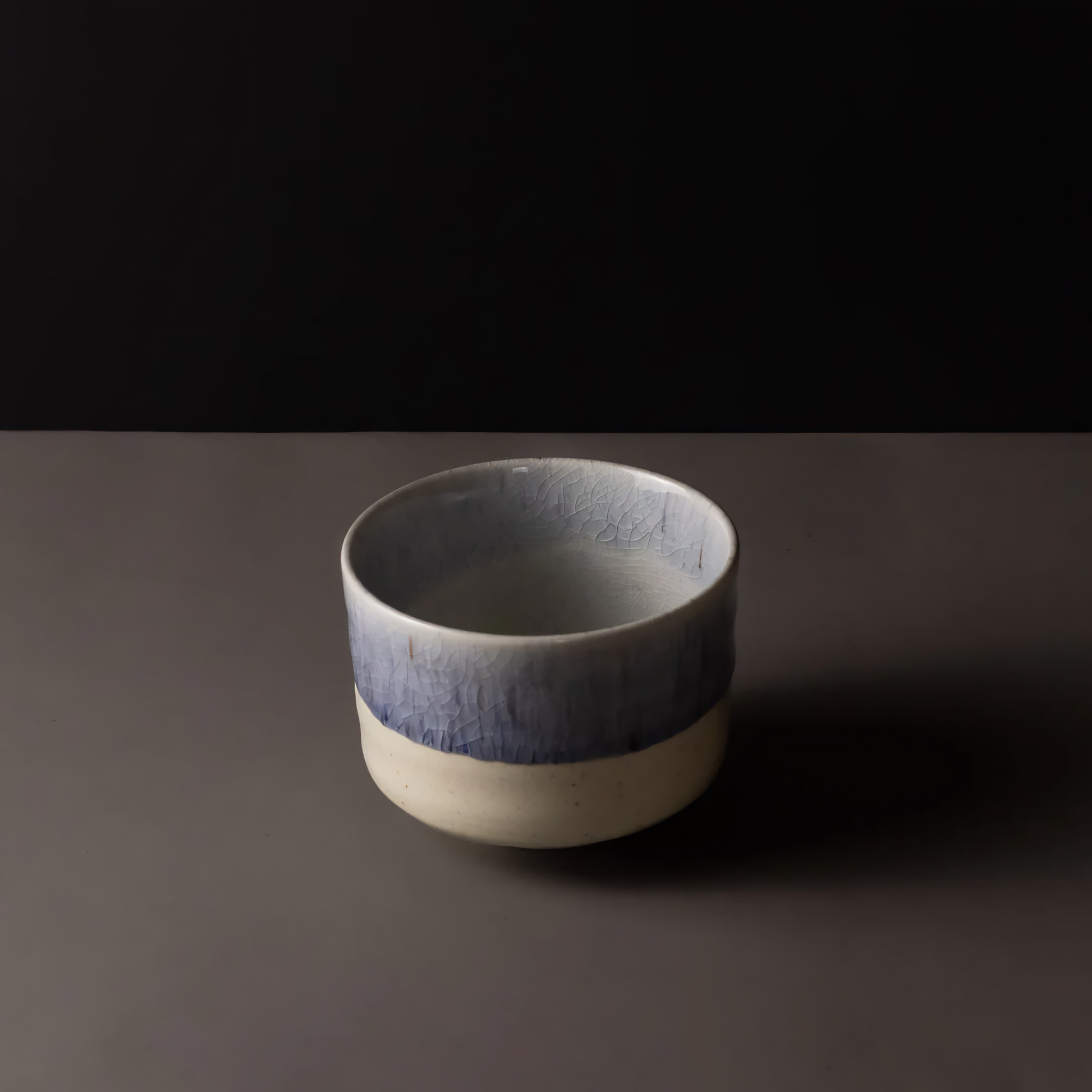 Semi top view of the Fathom Matcha Tea Bowl 10cm Winter Drift featuring a soft indigo glaze and a delicate speckled texture subtle crackle finish.