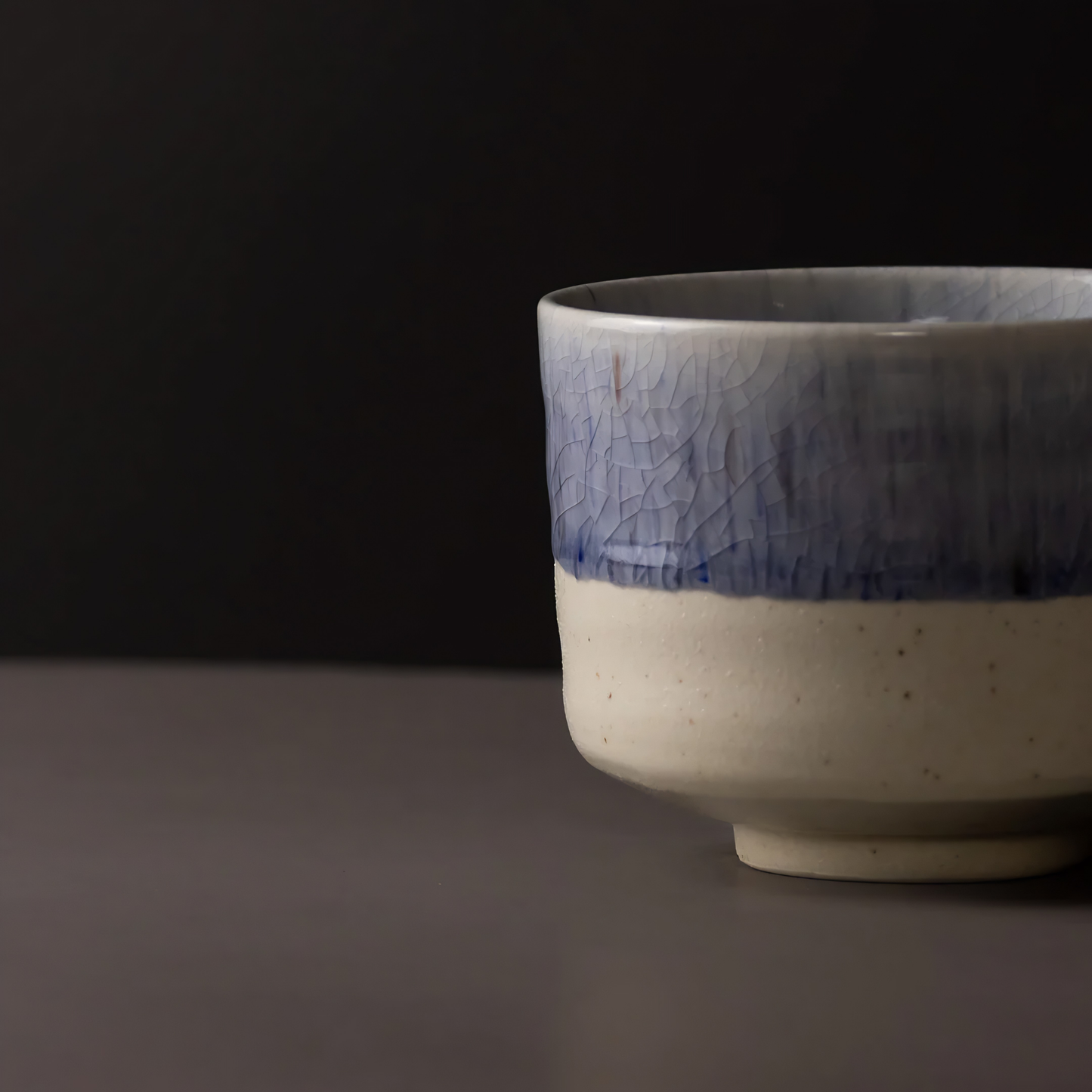 Close up view of the Fathom Matcha Tea Bowl 10cm Winter Drift featuring a soft indigo glaze and a delicate speckled texture subtle crackle finish.