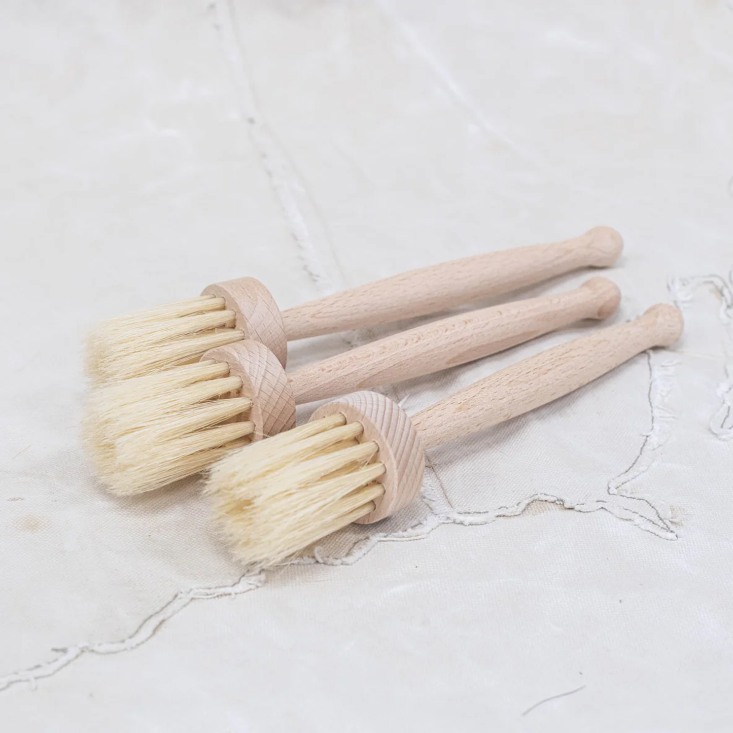 Showing on a table a group of Fathom Large Pastry Brushes, German-made natural bristles, 23cm butter brush, ideal for baking and basting.