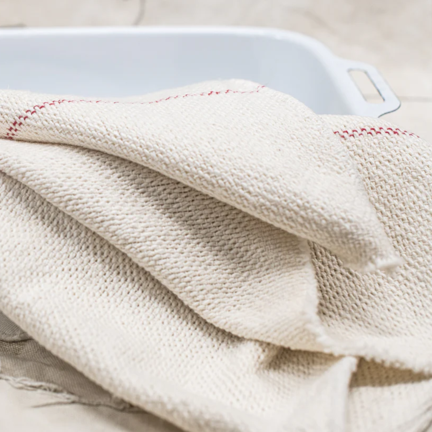 On a tray Fathom Red Stripe Selvedge Cloth, durable all-rounder with selvedge ends for versatile household and kitchen use.