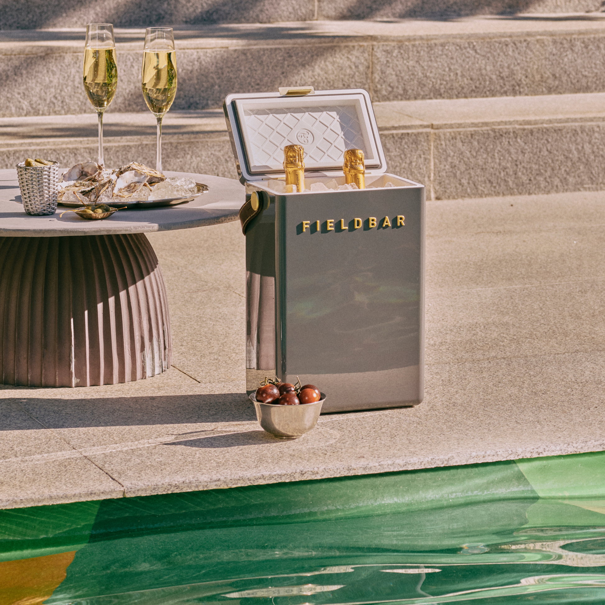 Open FIELDBAR Drinks Box MK II hardcase cooler, oyster grey, 10L capacity, durable and comfortable to carry, shown with 2 wine bottles inside.