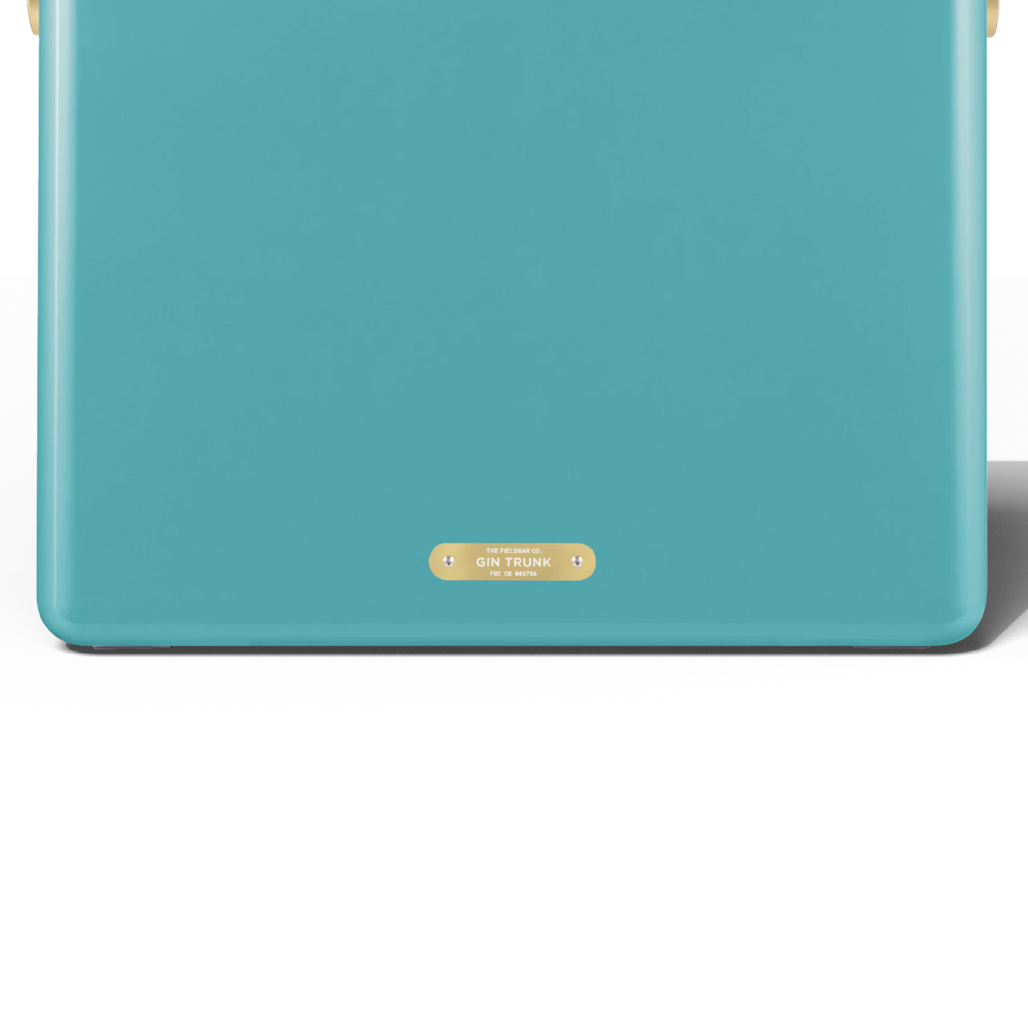 Upclose back view with the badge with the Gin Trunk writing from FIELDBAR Gin Trunk Bazaruto Blue - premium hardcase 24L cooler box in impact-resistant material with leather-wrapped handle, extruded aluminum carry handle, reflective heat-reducing finish, airtight gasket, BPA-free insulated interior, and 50-hour ice performance.