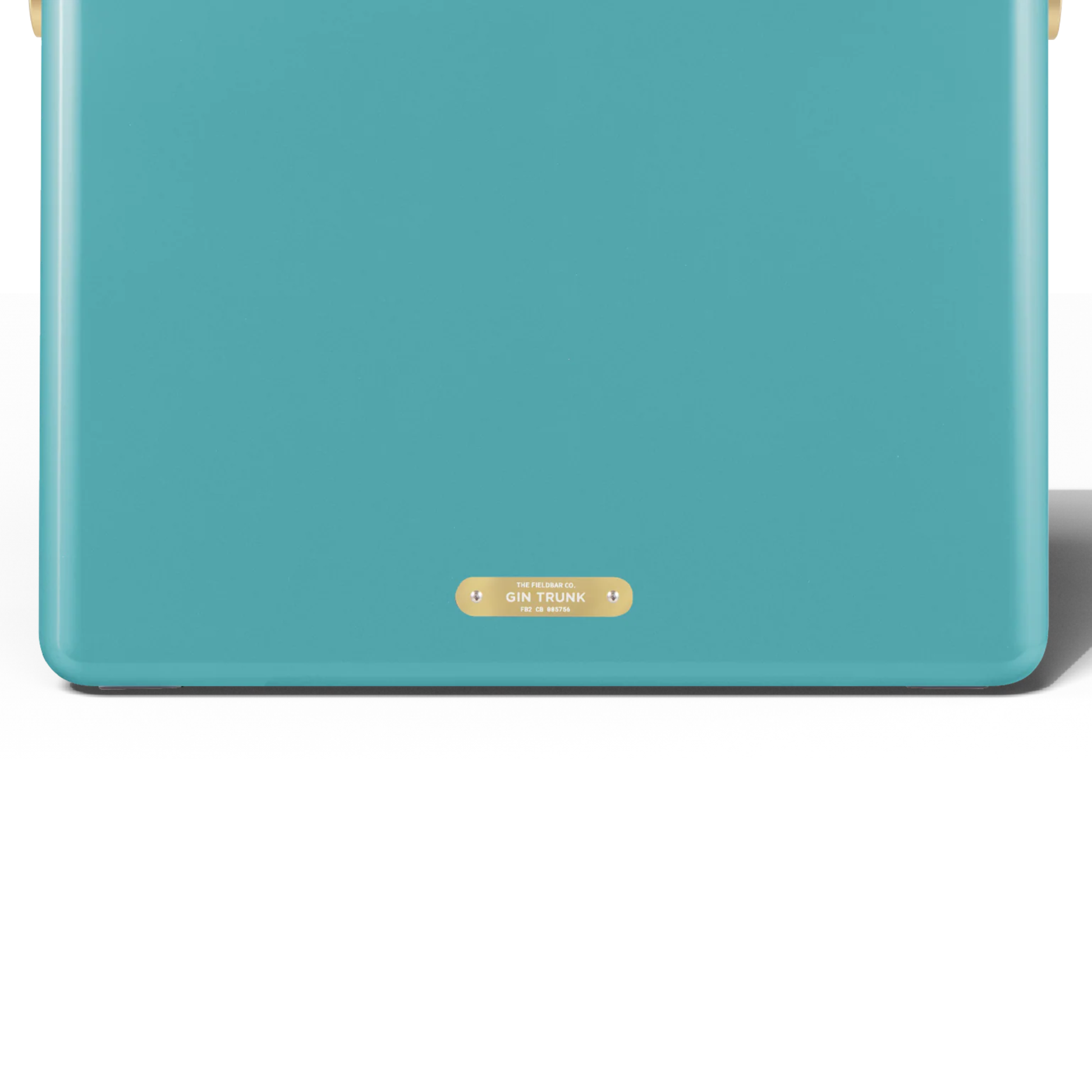Upclose back view with the badge with the Gin Trunk writing from FIELDBAR Gin Trunk Bazaruto Blue - premium hardcase 24L cooler box in impact-resistant material with leather-wrapped handle, extruded aluminum carry handle, reflective heat-reducing finish, airtight gasket, BPA-free insulated interior, and 50-hour ice performance.