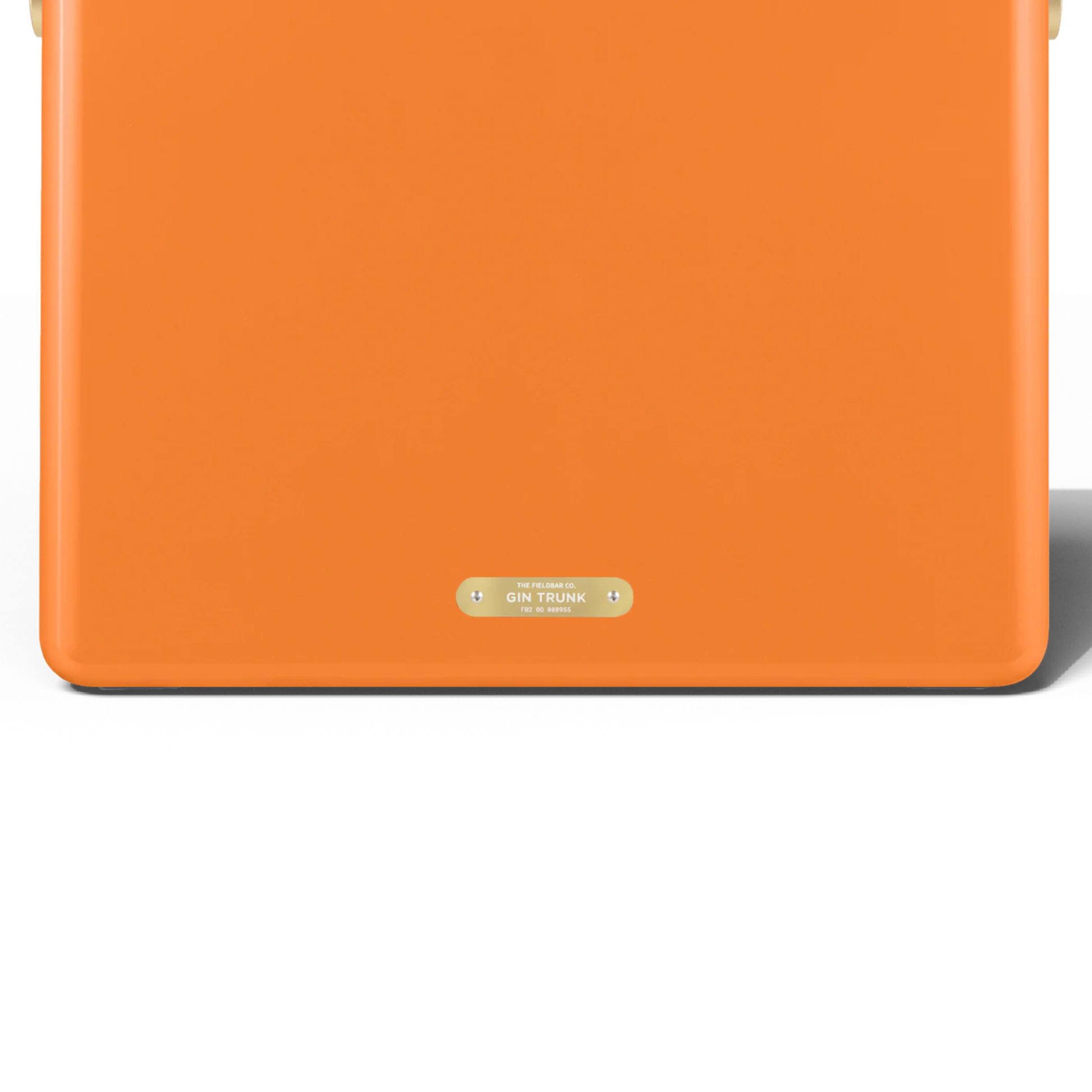 Upclose back view with the badge with the Gin Trunk lettering from FIELDBAR Gin Trunk Orchard Orange - premium hardcase 24L insulated cooler box in impact-resistant material with leather-wrapped handle, extruded aluminum carry handle, reflective heat-reducing finish, airtight water- and air-sealed gasket, BPA-free interior, removable foam insulation, and 50-hour ice performance.