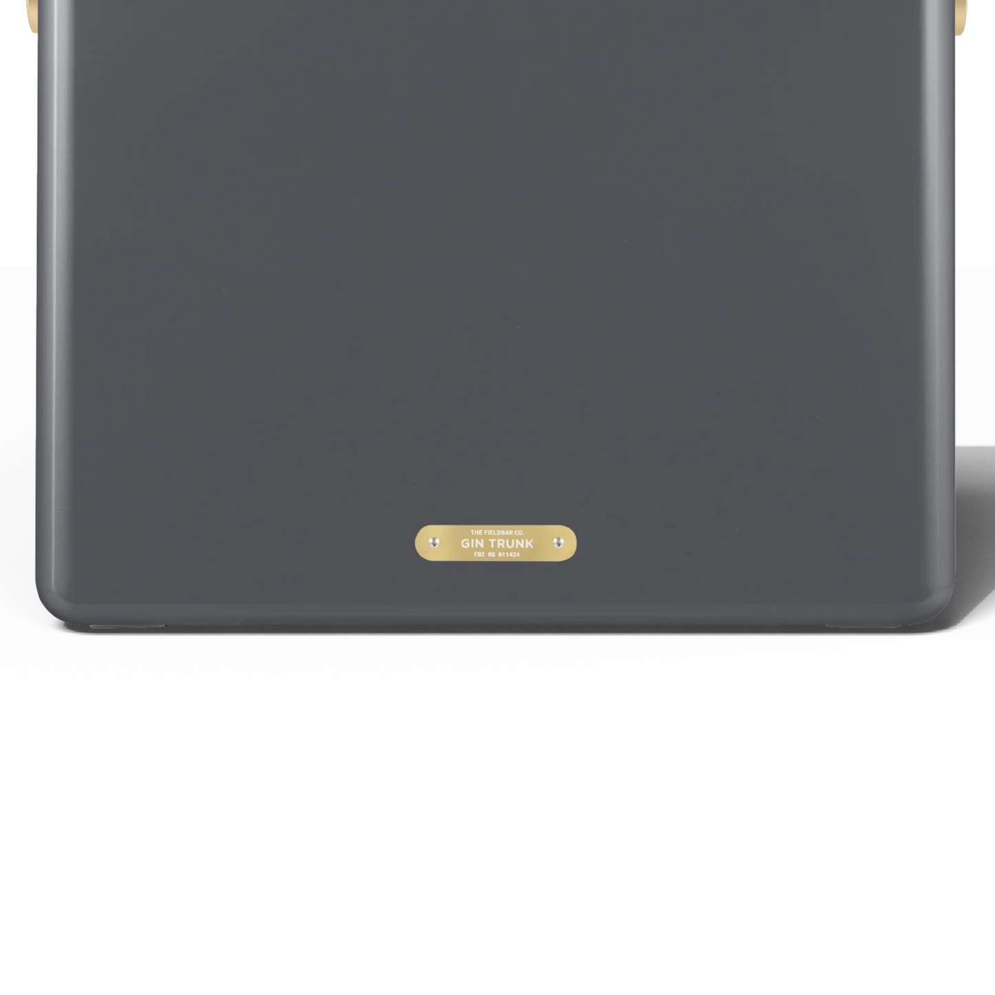 Upclose view of the back with the Gin Trunk badge from Fieldbar Gin Trunk hardcase cooler - oyster grey insulated box made with impact-resistant plastic, aluminium hardware, leather-wrapped handle, and BPA-free interior; 24L capacity with 50-hour champagne-cold performance.