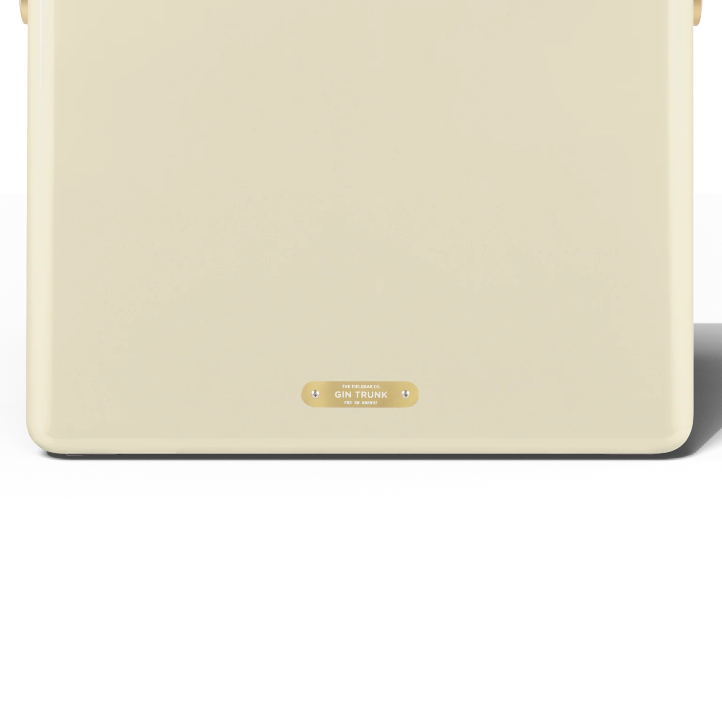 Upclose back view with the badge that has a Gin trunk writing from FIELDBAR Gin Trunk Safari White - premium hardcase 24L insulated cooler box in white impact-resistant material with leather-wrapped handle, extruded aluminum carry handle, reflective heat-reducing finish, airtight water- and air-sealed gasket, BPA-free interior, removable high-performance insulation, and 50-hour ice retention.