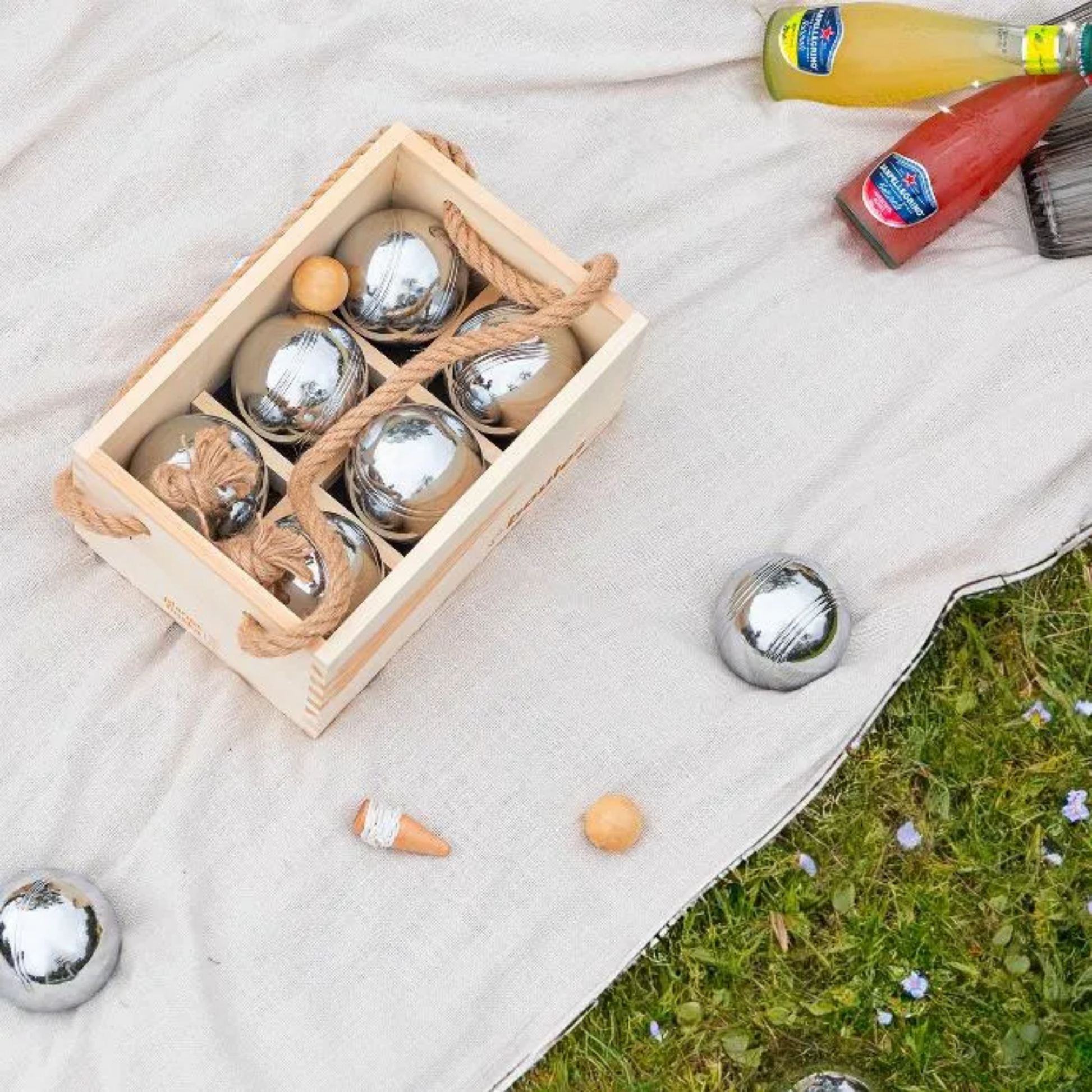 Tradditional boules game shown with top view on picnic rug