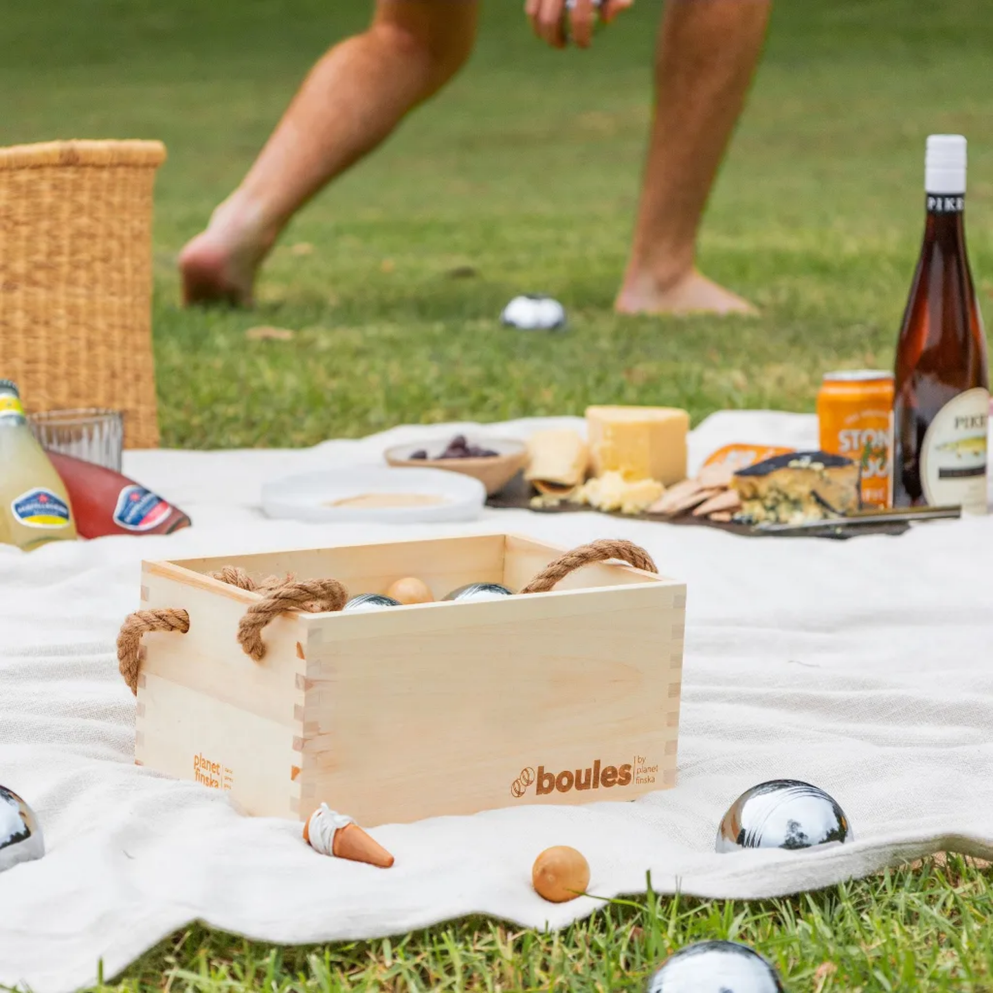 Tradditional boules game shown with side view on picnic rug