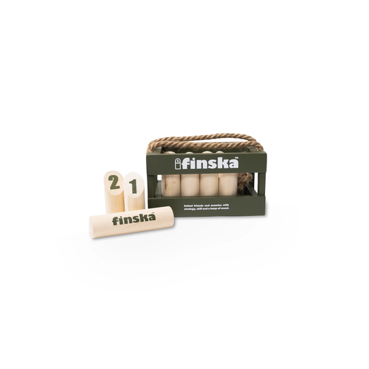 Finska Mini natural birch indoor and outdoor throwing game set, Moss green, includes 12 small numbered pins, a mini throwing log, birch carry crate, rule card, and score sheet. Compact and eco-friendly version of the original Finska.