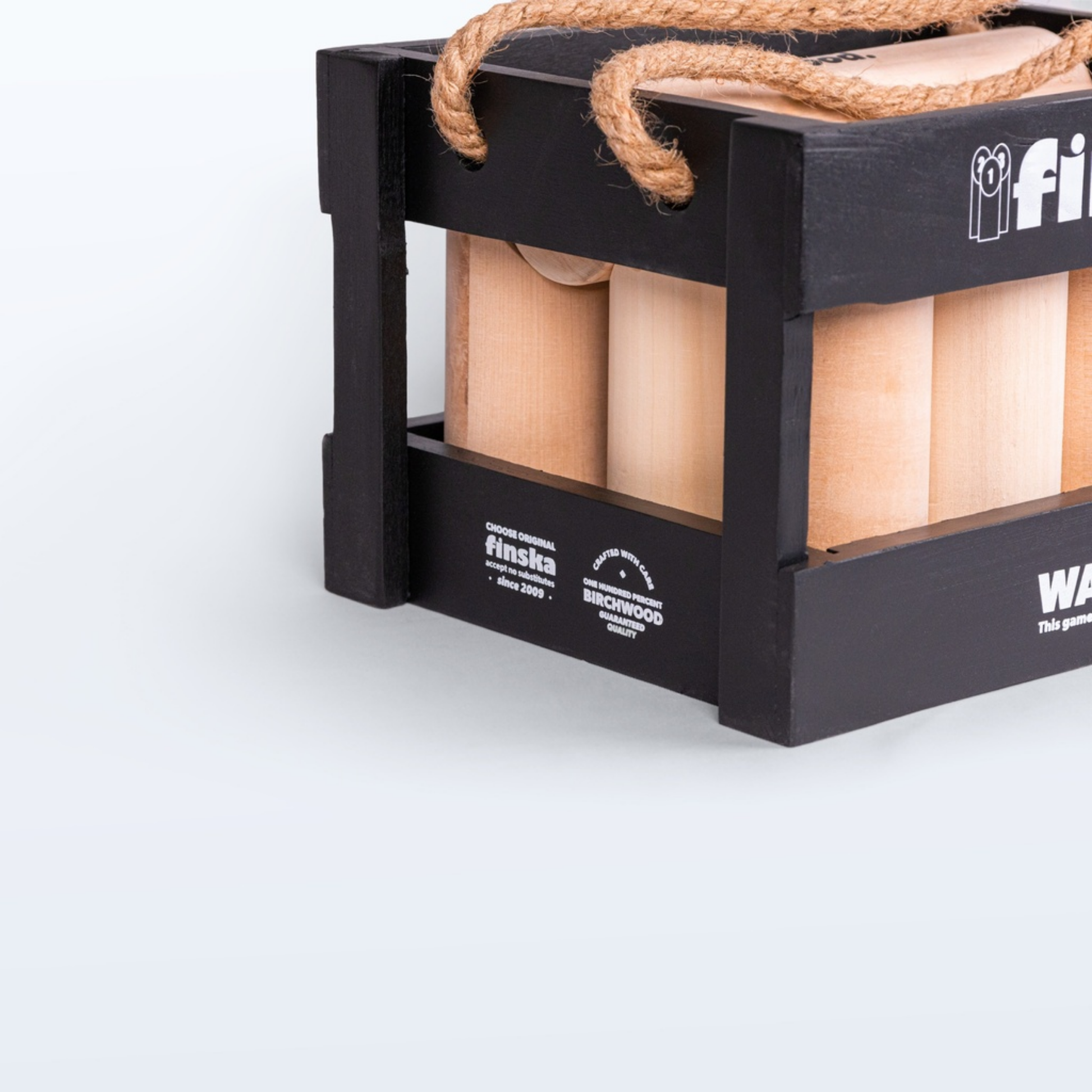 Left side view of Finska in Charcoal Black outdoor throwing game set made from eco-friendly birch hardwood, includes 12 numbered pins, a throwing log, and a black painted carry crate.