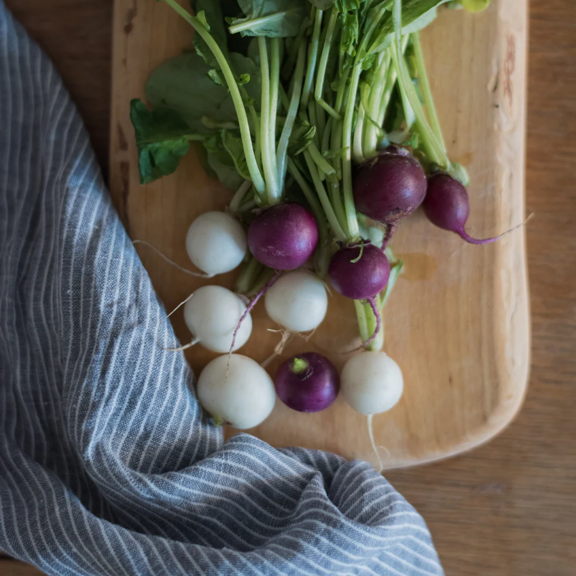 Fog Linen cloth tea towel grey and white striped on wooden chopping board with raddishes 