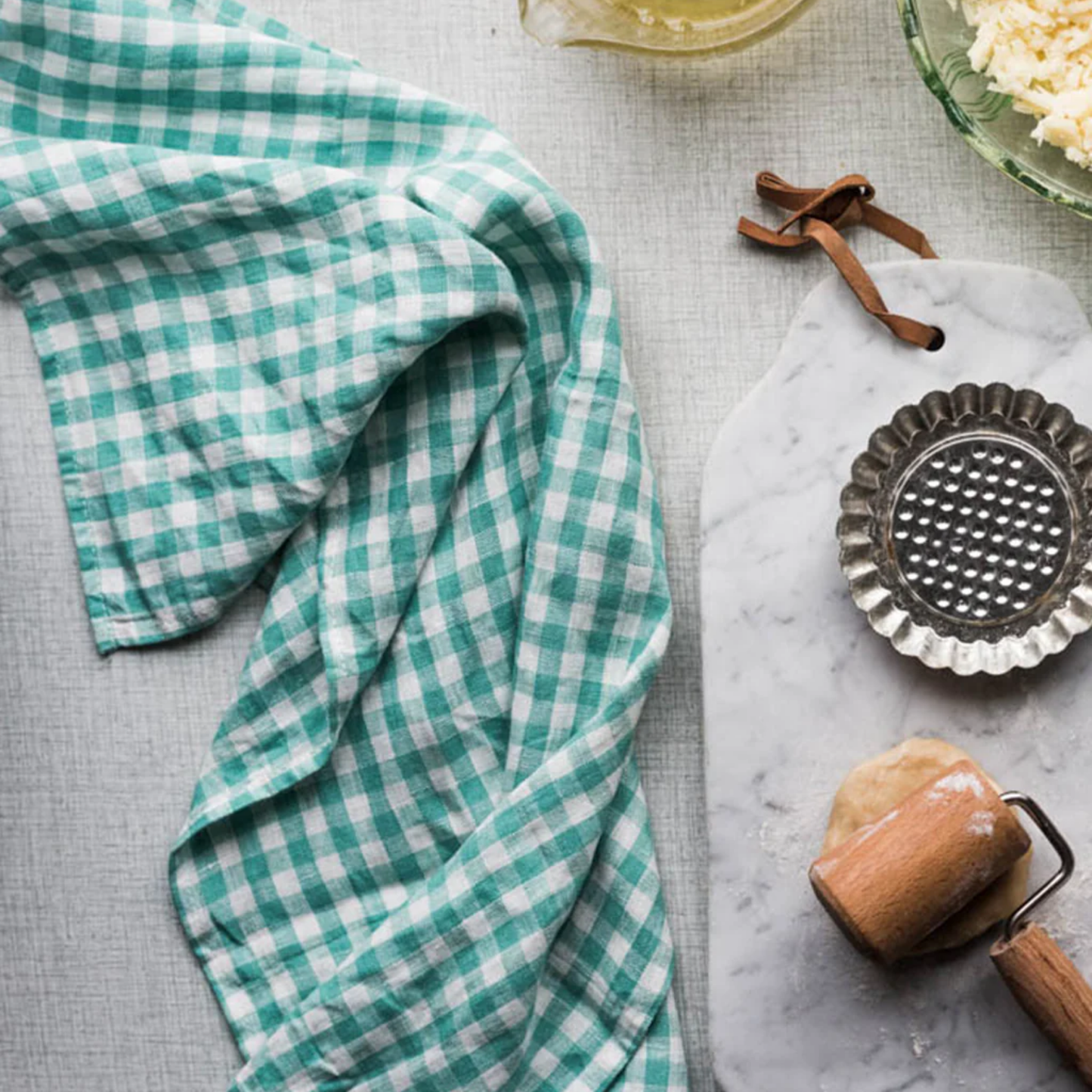 Fog Linen cloth tea towel jules on marble countertop with baking equipment top view