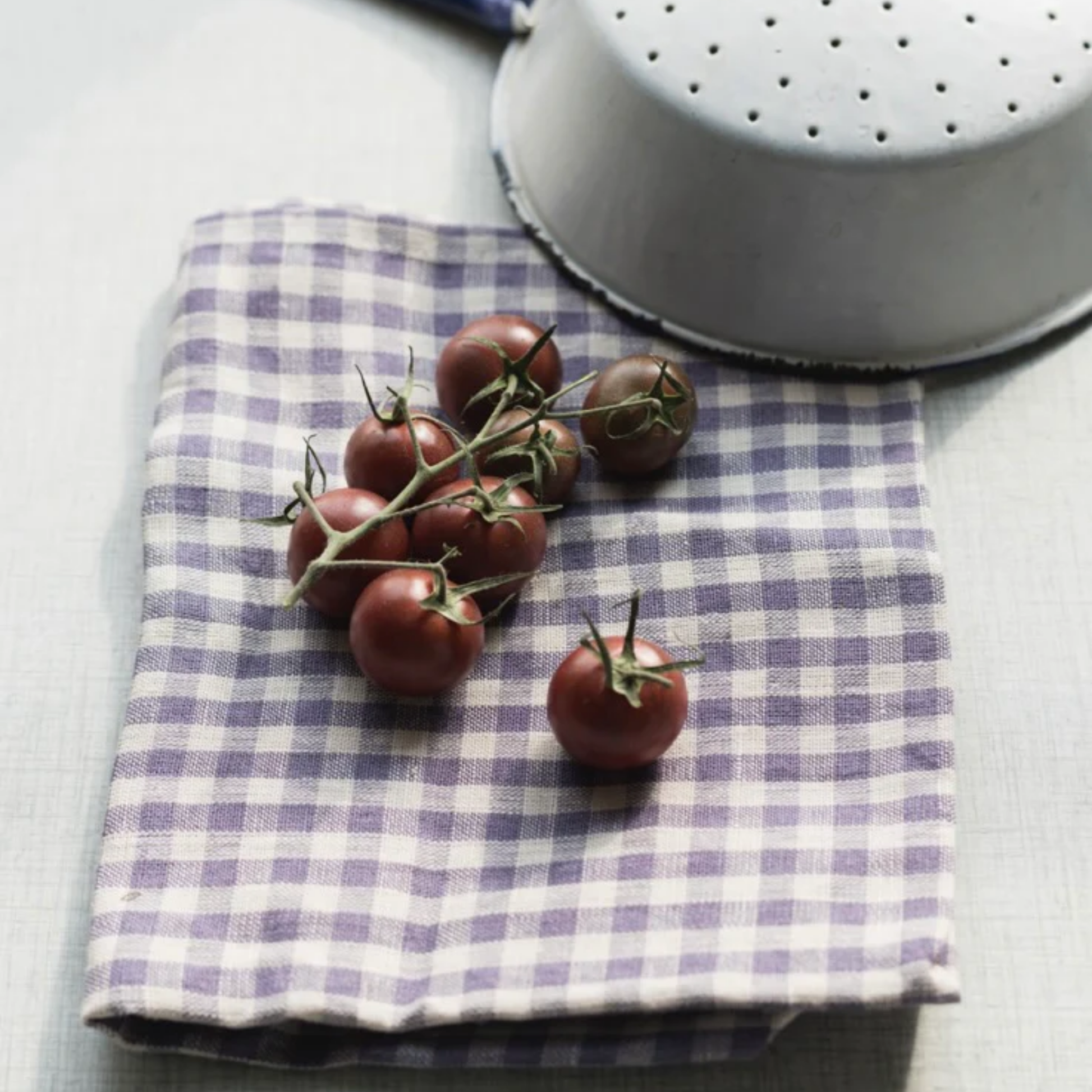 Fog Linen cloth tea towel simone folded on kitchen table underneath tomatoes 