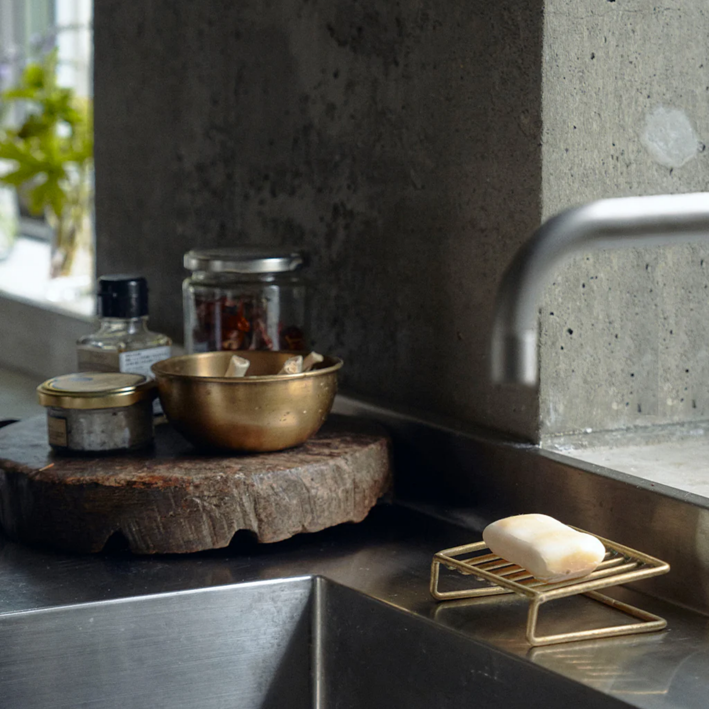 Fog Linen brass soap stand front on display in kitchen sink holding soap