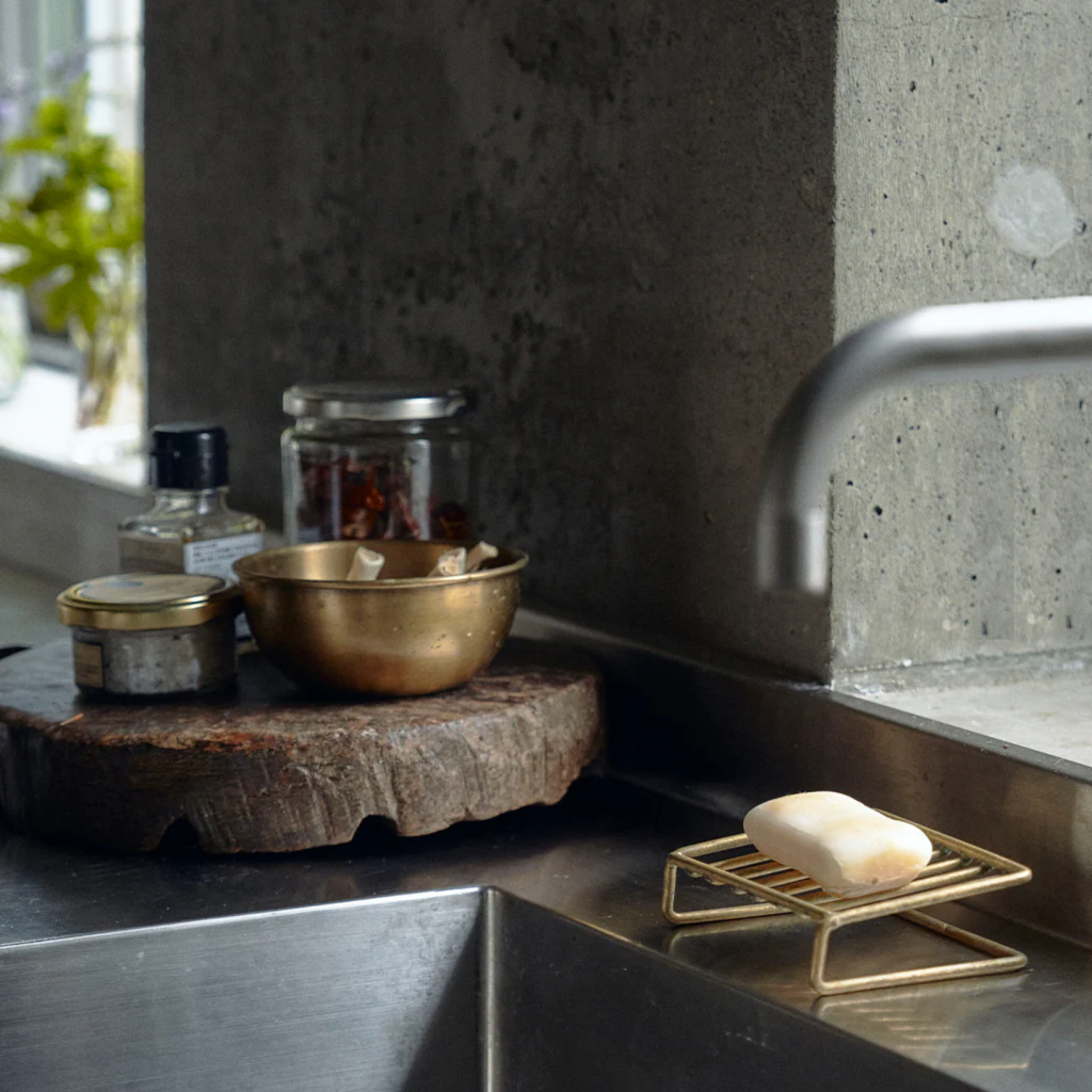 Fog Linen brass soap stand front on display in kitchen sink holding soap
