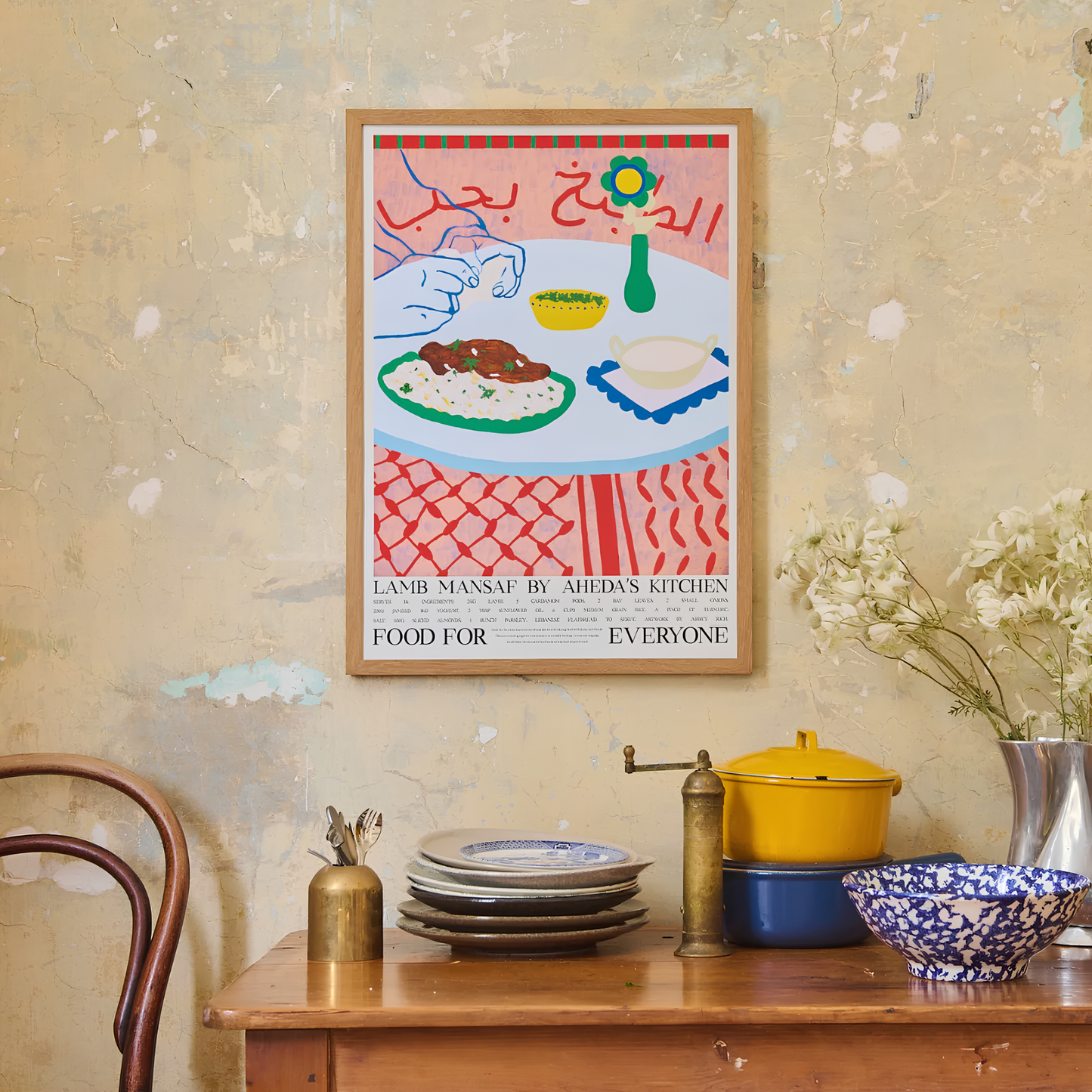Hung on the wall, the Food For Everyone Poster A2 Lamb Mansaf an illustration of a spiced slow-cooked lamb with rice and a tangy jameed yoghurt sauce with recipe.