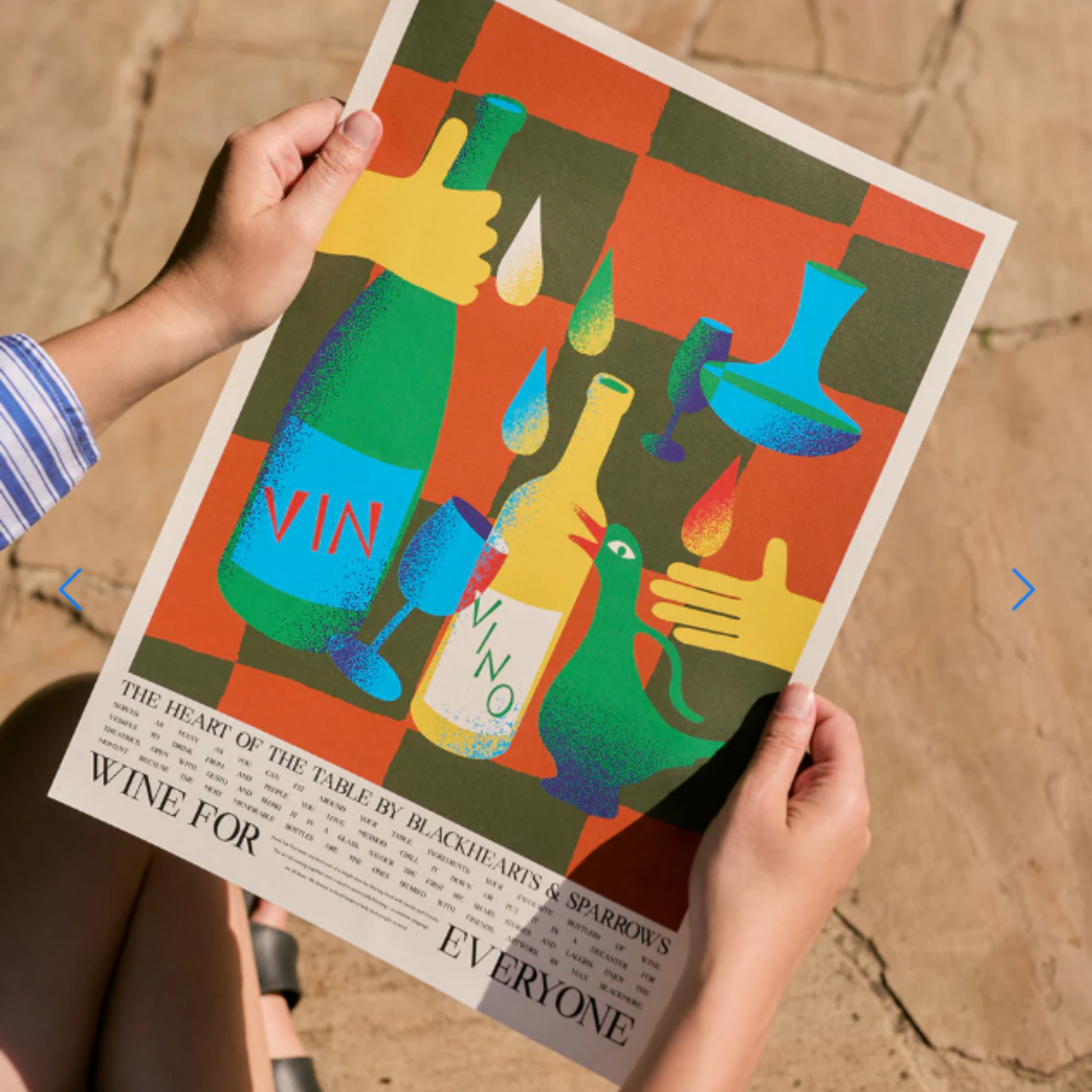 Being held Food for Everyone Wine Poster created with Blackhearts & Sparrows and artist Max Blackmore, featuring warm wine tones that celebrate shared meals and laughter; printed on recycled paper, unframed