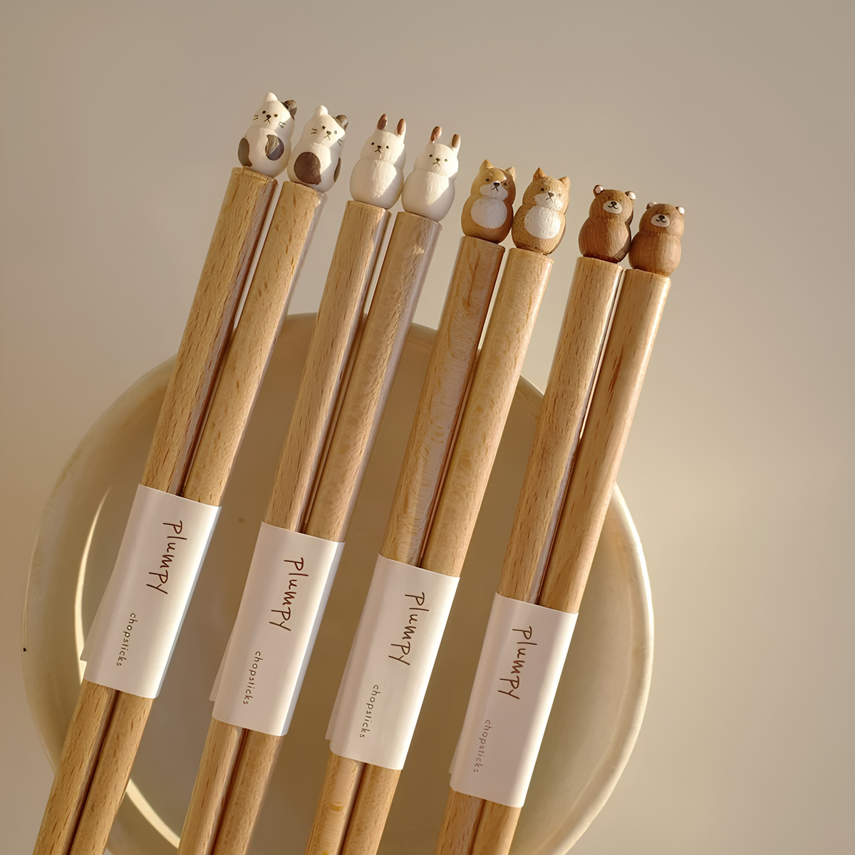 Dog, bear, cat chopsticks with the Grapport Plumpy Wood Chopsticks Rabbit on a plate, these are handmade in Japan inspired by place of origin, 22.5cm.