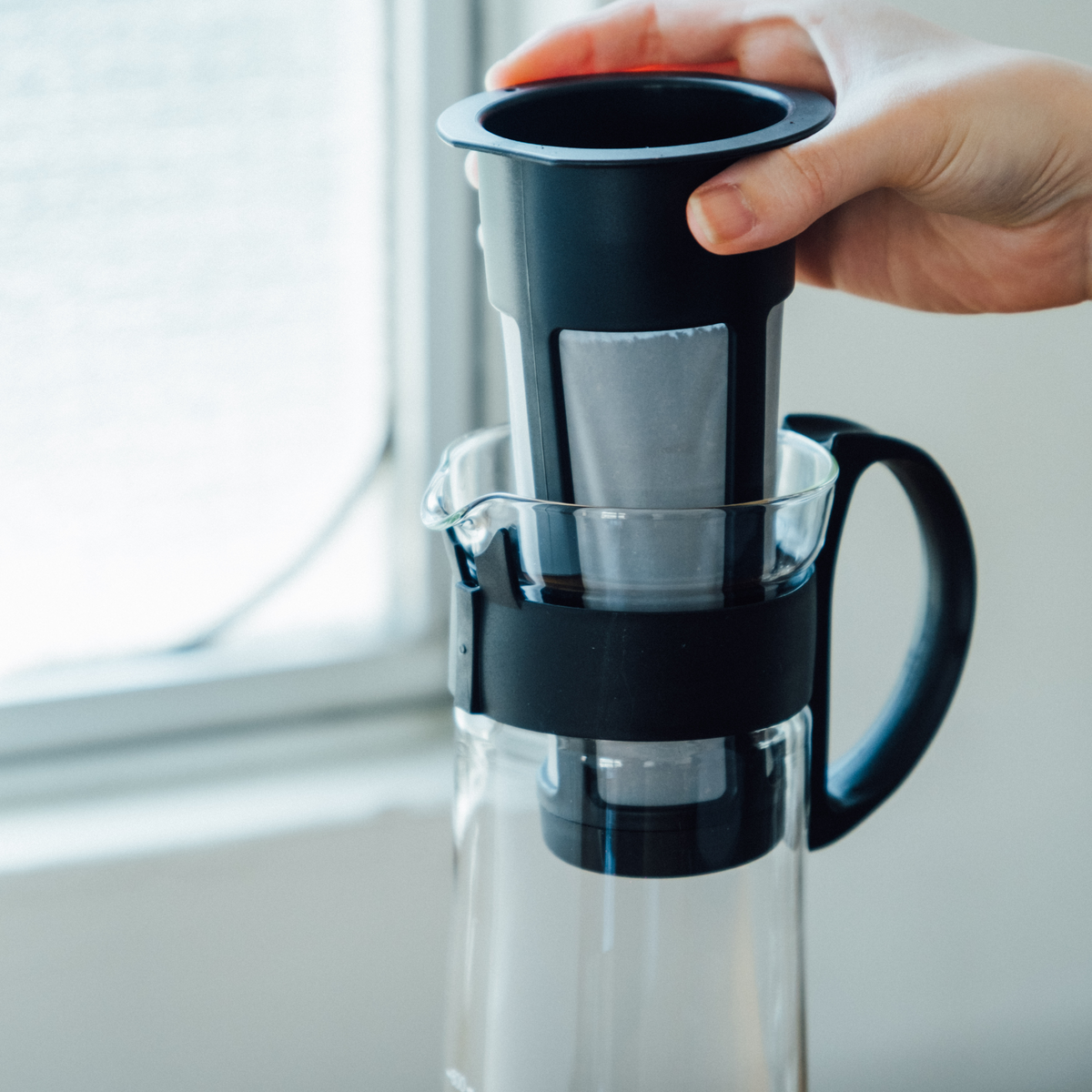 Putting the strainer inside the Hario Cold Brew Coffee Pot Glass Black that is made from durable heatproof Hario glass, foolproof design with 1L capacity.