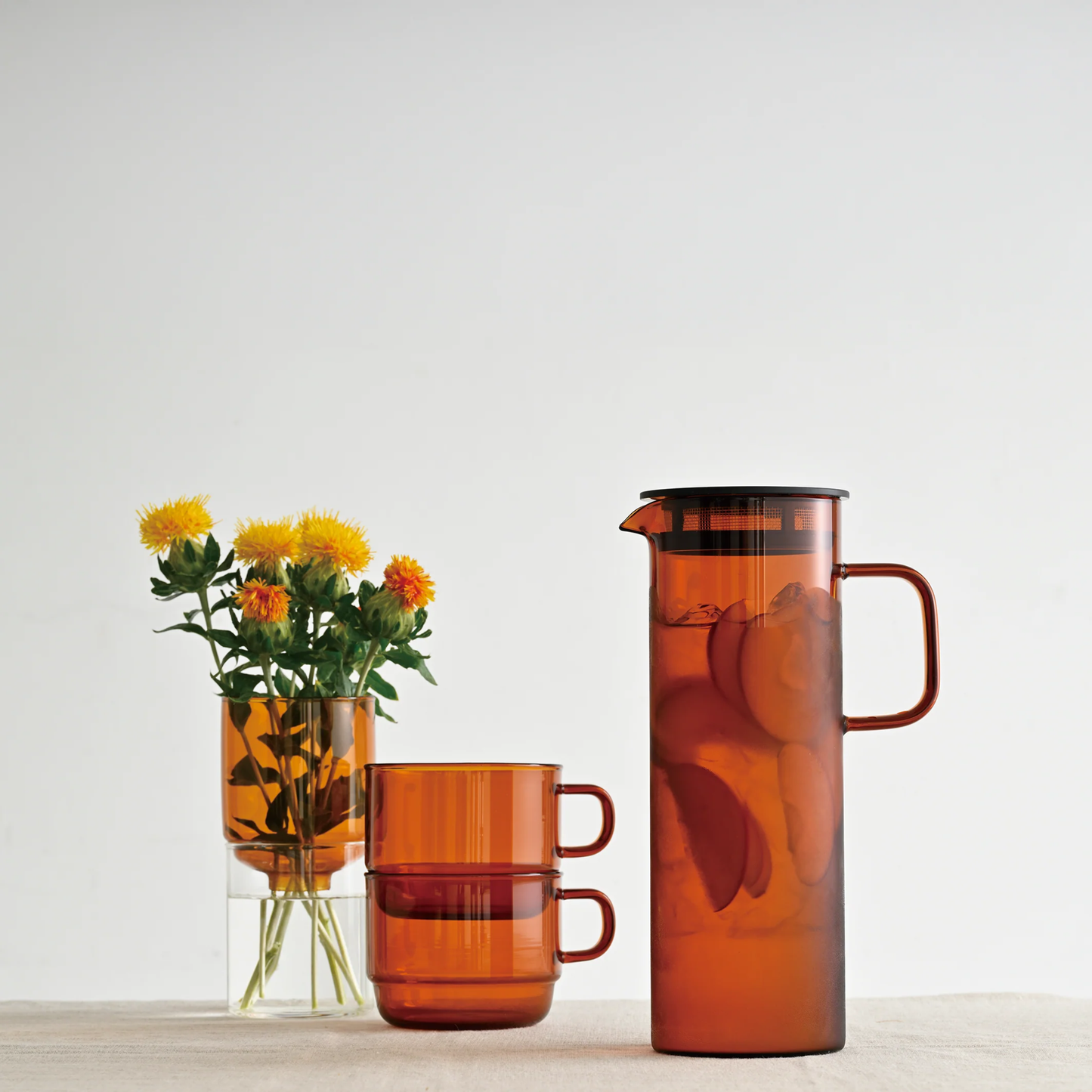 Stacked on the table Hario Glass Stacking Mug Amber that is made from heatproof glass, for 300ml capacity.