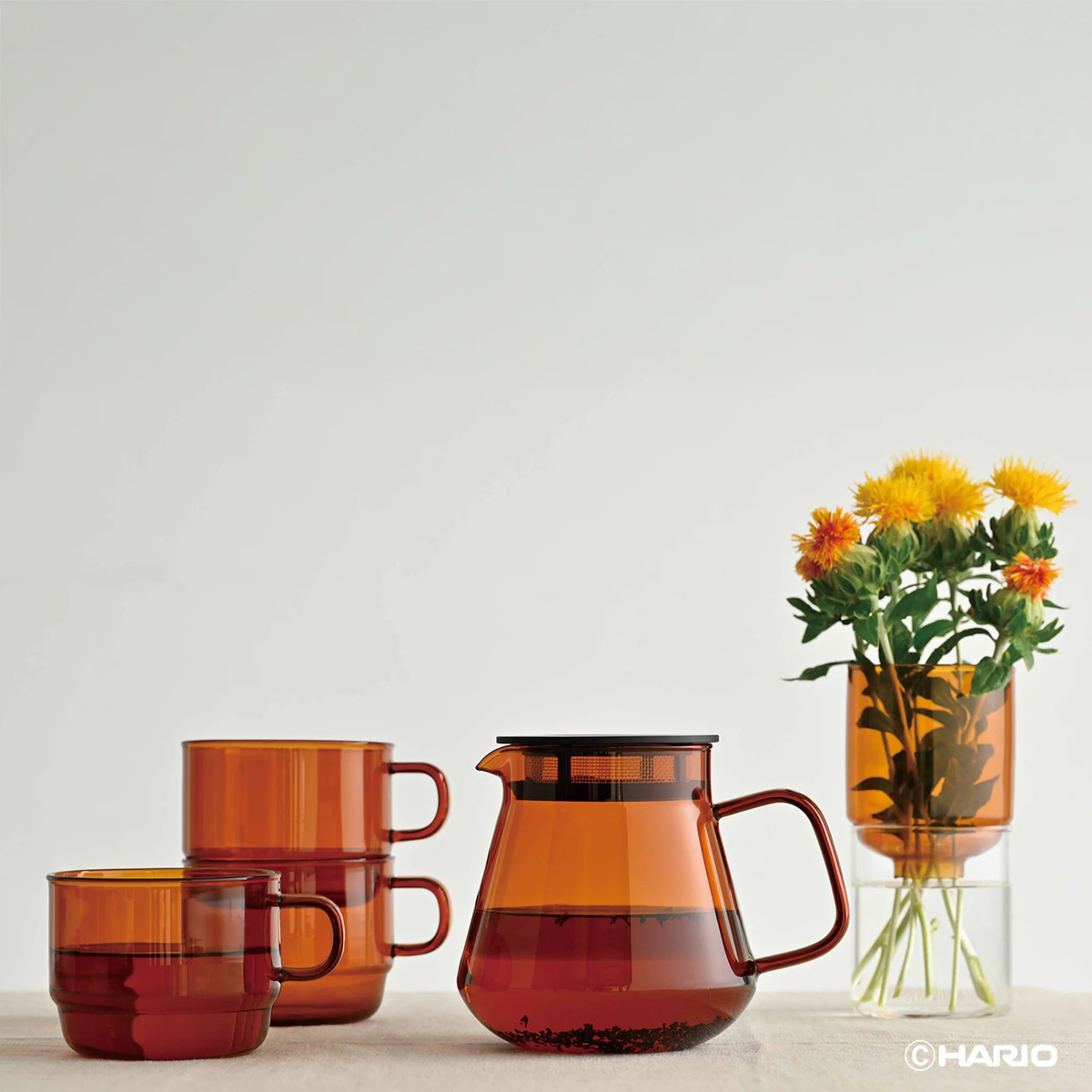 Side view on the table of Hario Glass Tea Server Amber which is made from heatproof glass, can also be used to contain the dripped coffee.