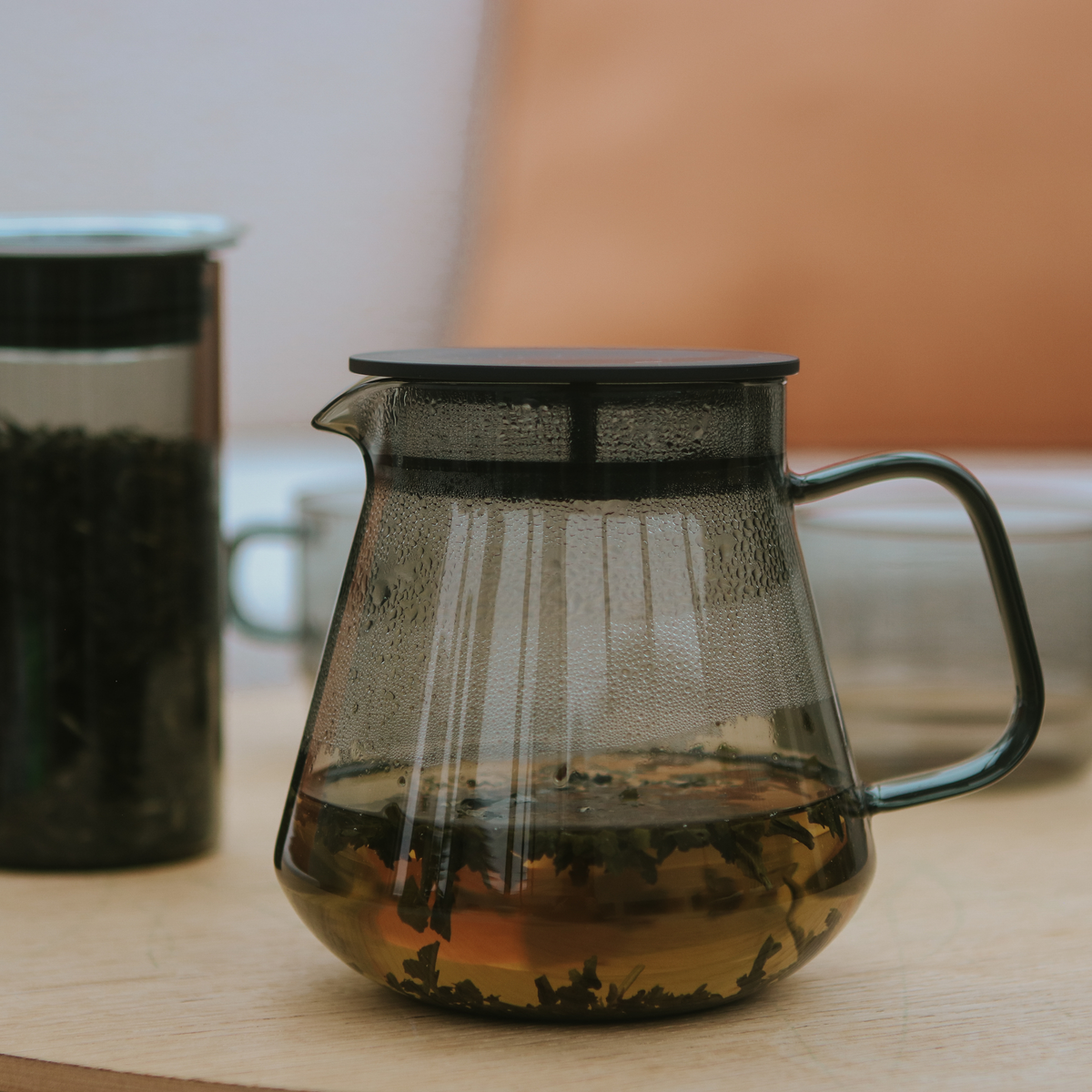 Side view of the Hario Glass Tea Server Grey with tea insde, which is made from heatproof glass, can also be used to contain the dripped coffee.