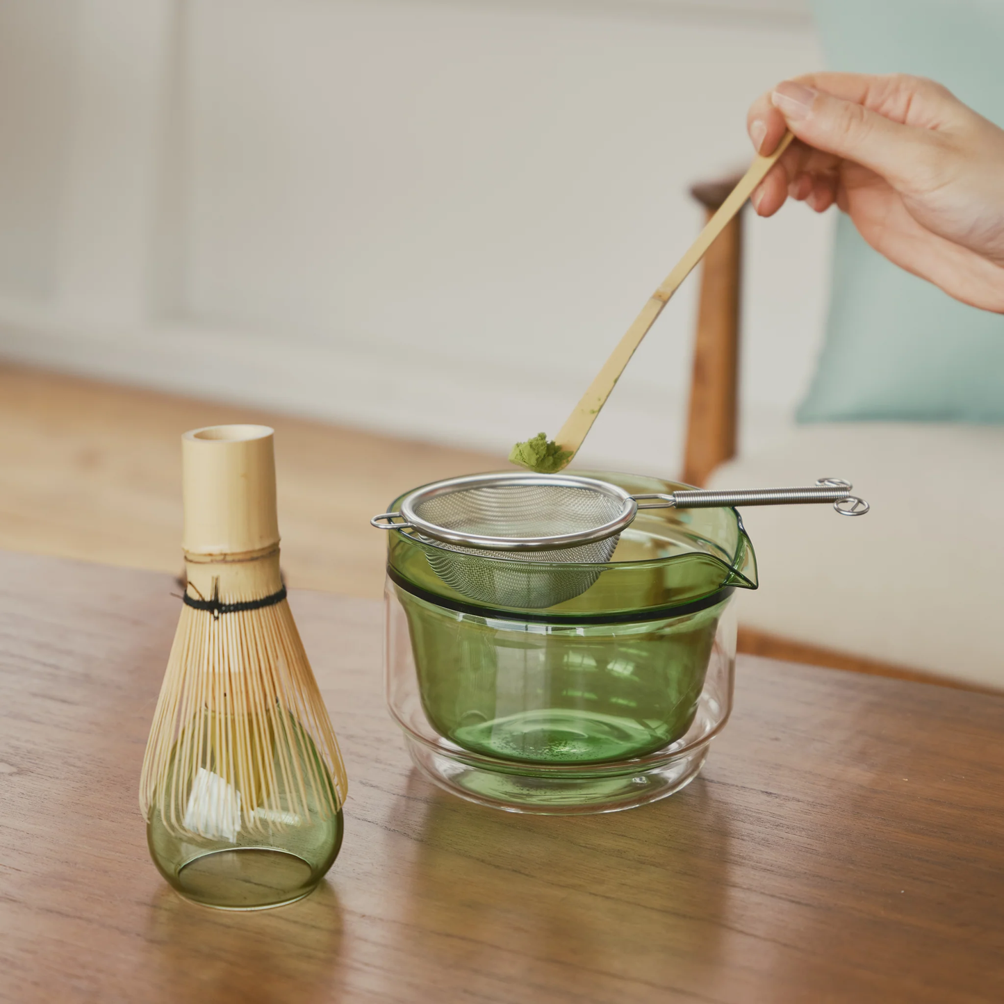 Set for preparing matcha tea using the Hario Matcha Tea Set Green which includes Double-walled Matcha Bowl, stand from heatproof glass, Chasen or the whisk, chashaku or measuring spoon from bamboo and tea sifter from stainless steel.