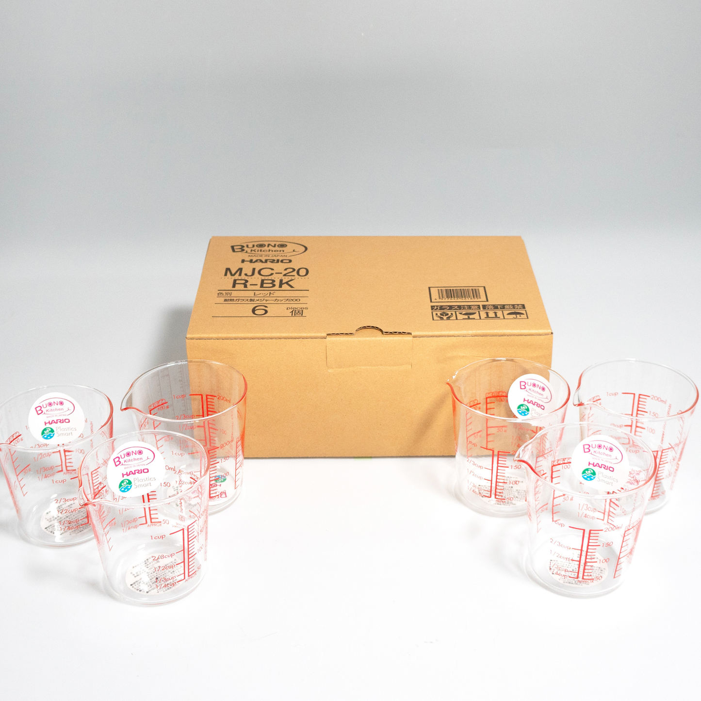 Group of HARIO Measuring Cup, 200mL capacity, red markings for easy visibility from above, heatproof glass for microwave or hot water use, includes measurements for liquids, sugar, and flour.