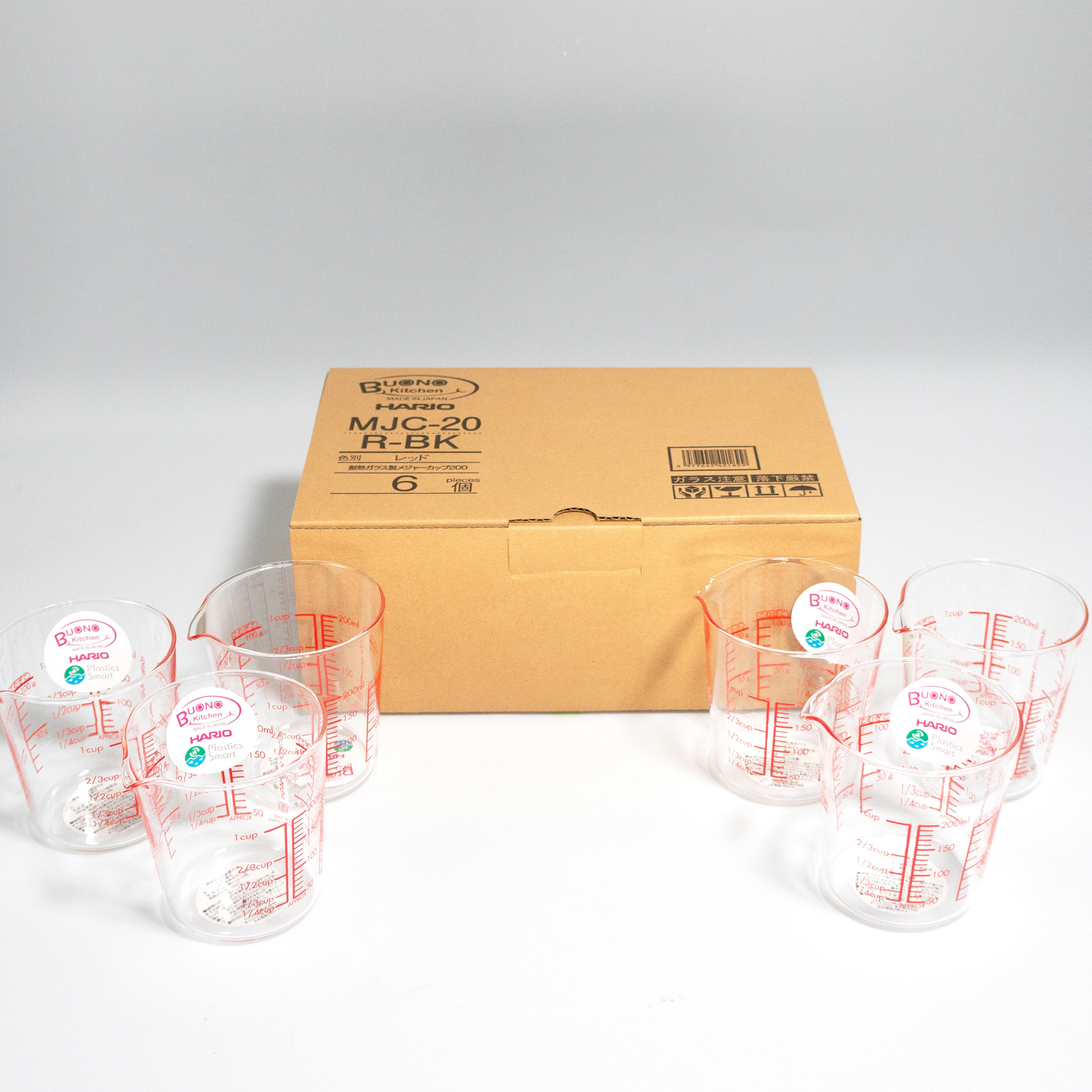 Group of HARIO Measuring Cup, 200mL capacity, red markings for easy visibility from above, heatproof glass for microwave or hot water use, includes measurements for liquids, sugar, and flour.