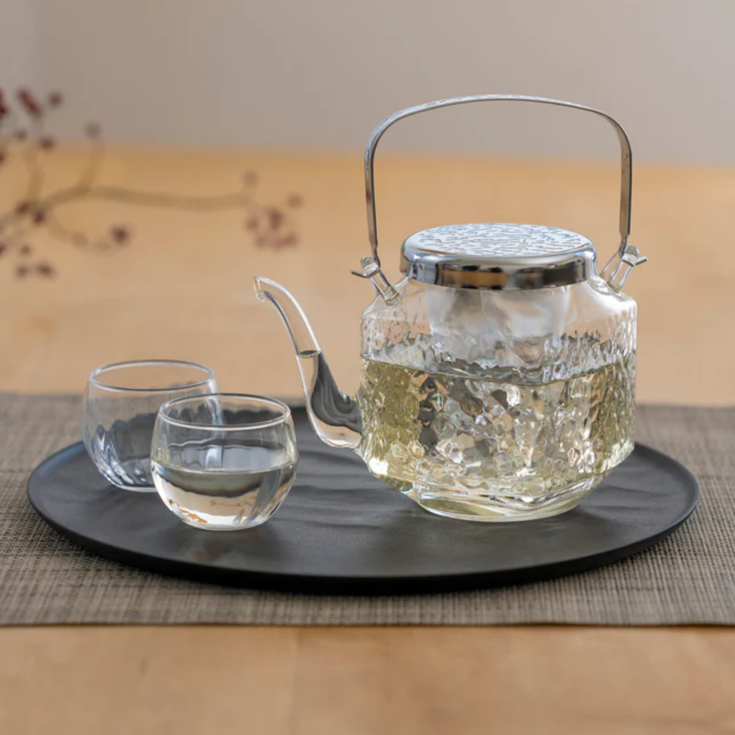 Table view of HARIO Chirori Sake Pot Set, heatproof glass body with stainless steel lid and brass knob, includes glass ice holder to chill without dilution, 360mL capacity, made in Japan.
