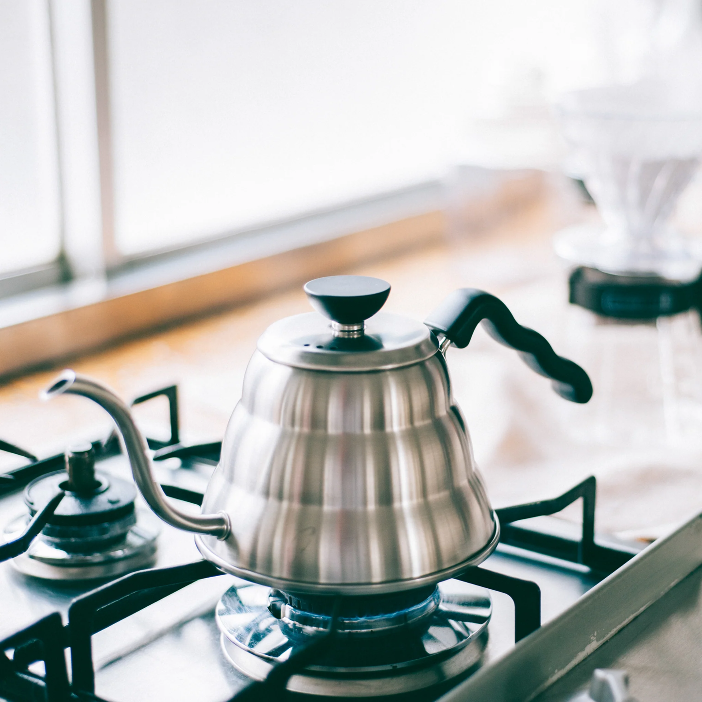 On the stove with Hario V60 Drip Kettle Buono 1L Stainless steel with slim spout for control pouring, for manual brewing.