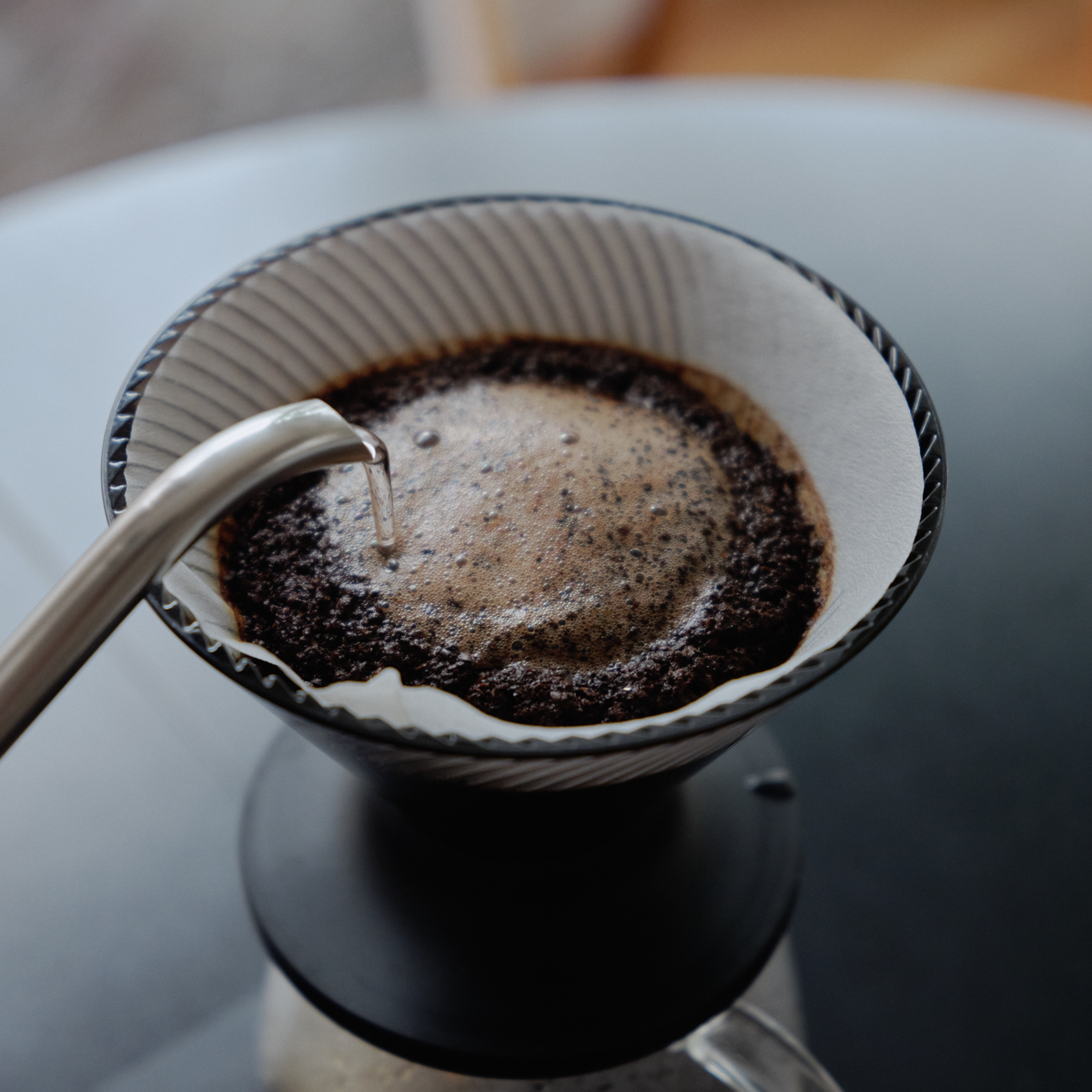 Dripping coffee from Hario V60 Neo Coffee Dripper 02 Black which is made from PCT resin and silicone rubber, with detachable base for hybrid brewing.