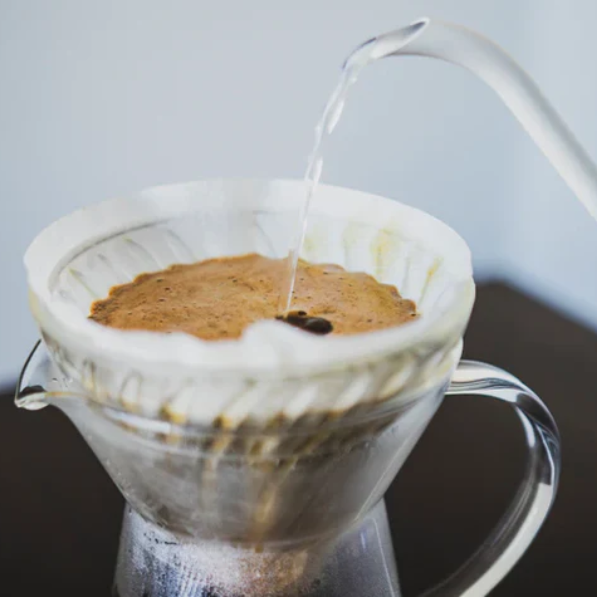 Upclose coffee filtering using the HARIO V60 coffee paper filters 02 natural brown unbleached paper pulp designed for V60 drippers for clear and balanced coffee, 1 to 4 cup capacity.