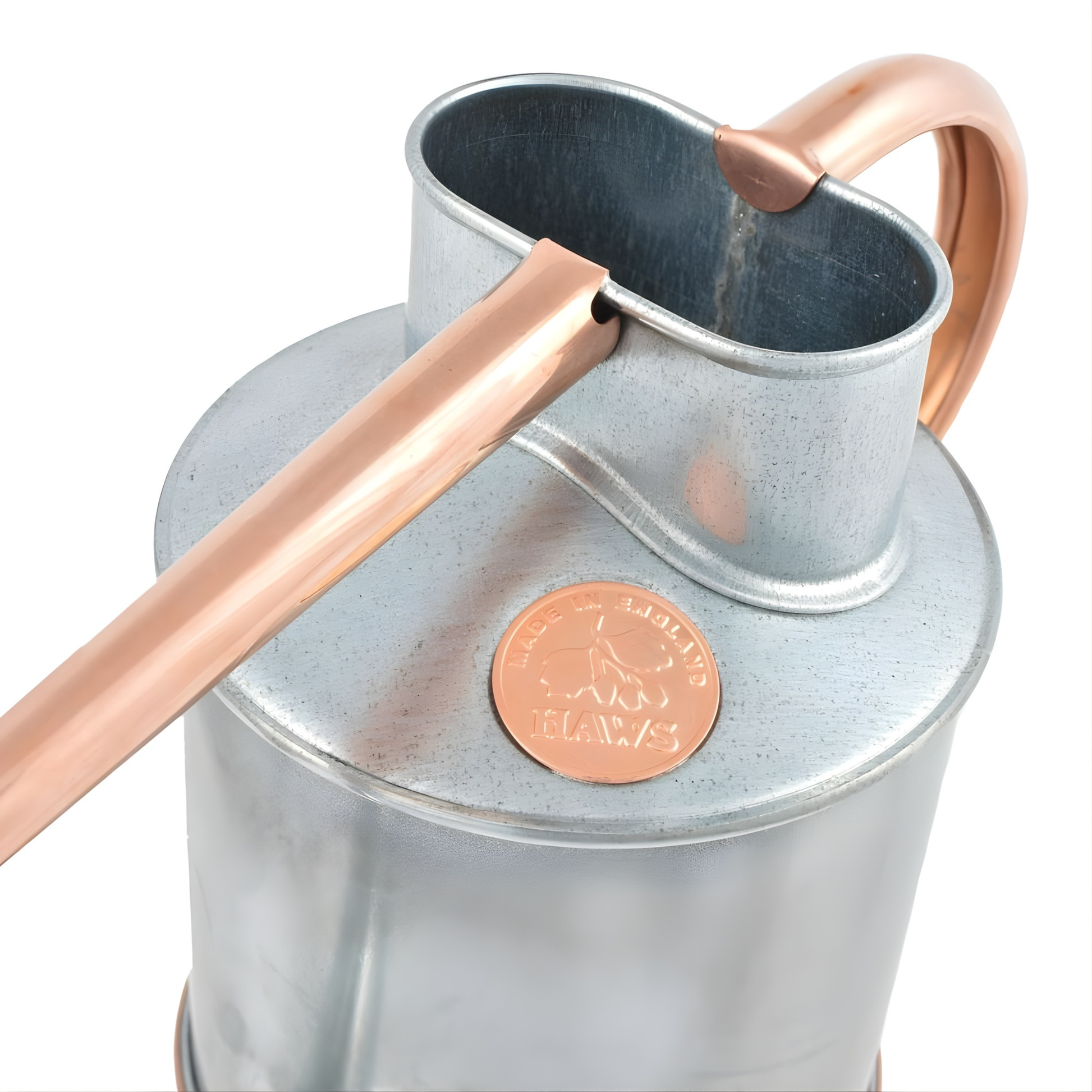 Rested on a surface, the Haws Watering Can Fazeley Flow Two Pint Copper Edition indoor metal watering can for potted houseplants.
