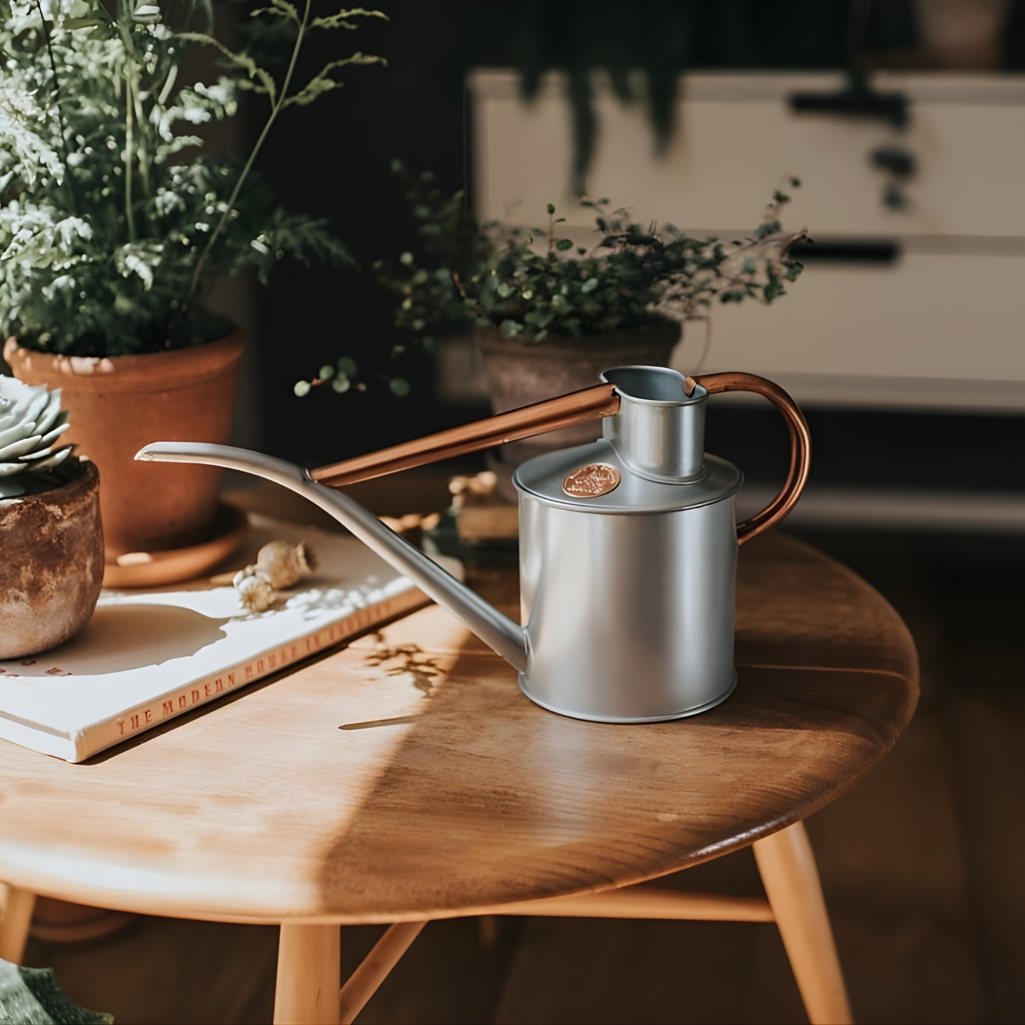 Top view and close up view of the logo of the Haws Watering Can Fazeley Flow Two Pint Copper Edition indoor metal watering can for potted houseplants.