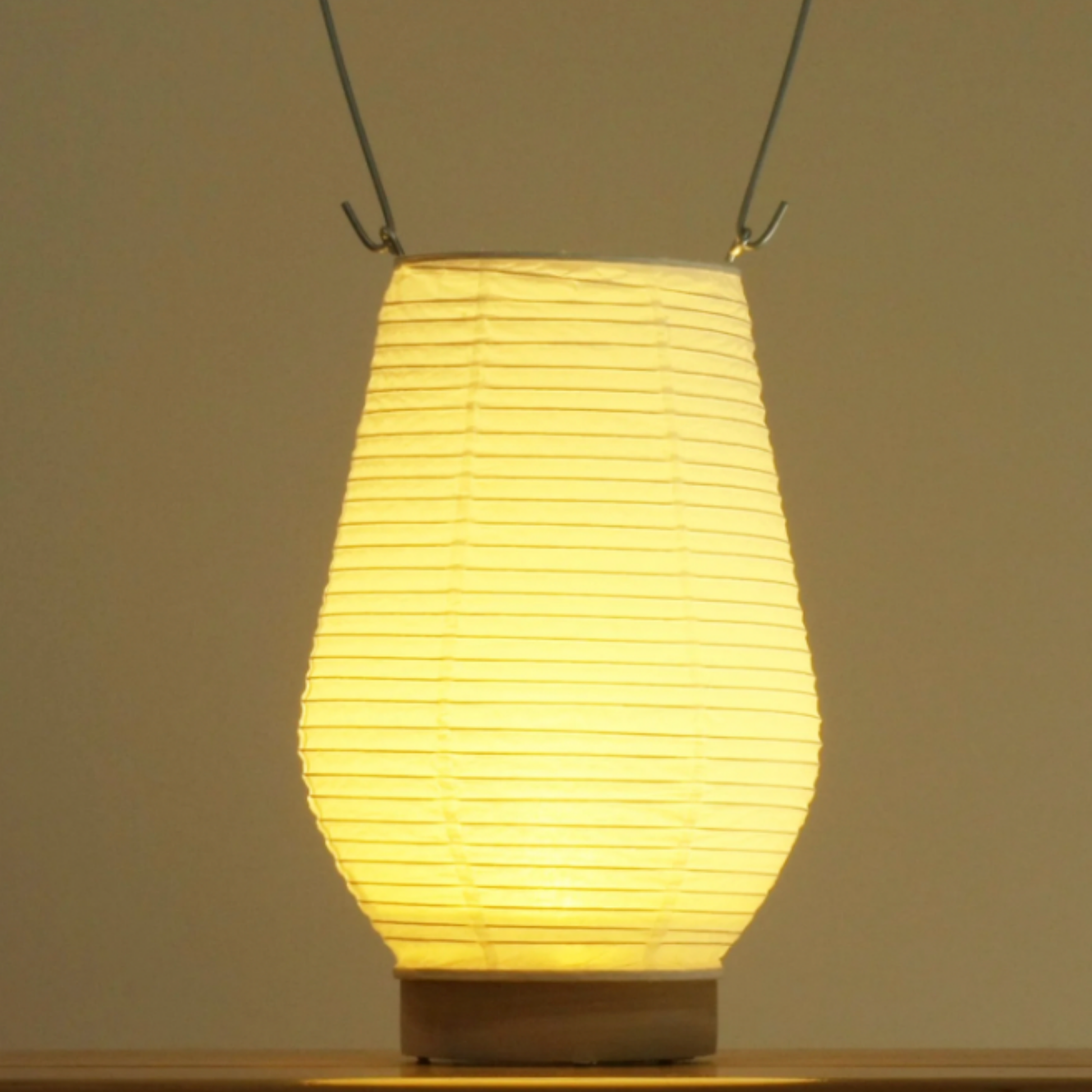 Hayashi Kougeu paper lantern switched on front view close up on wooden table