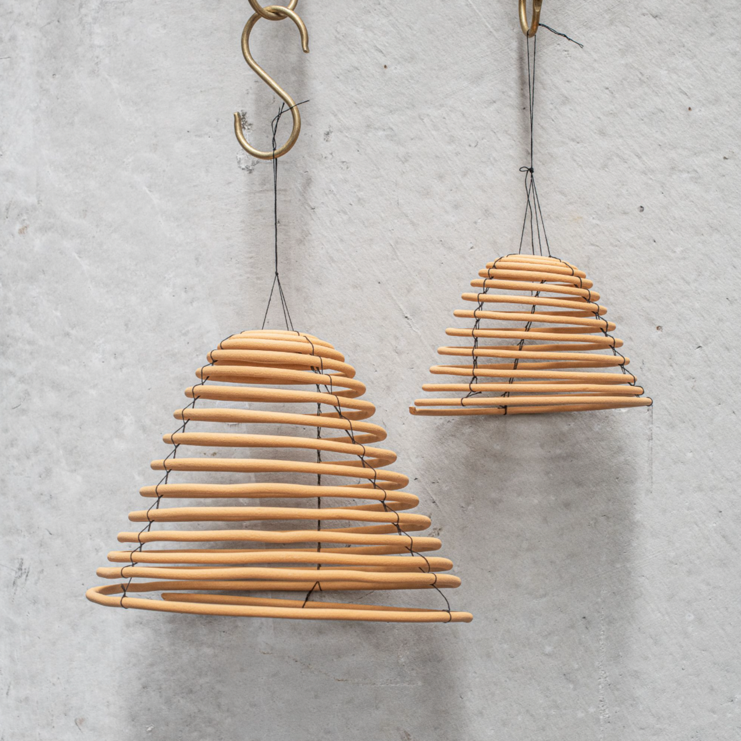 Heaven in Earth Citronella Coil Hanging Large with small citronella coil out of packaging displayed hanging off brass hook un coiled