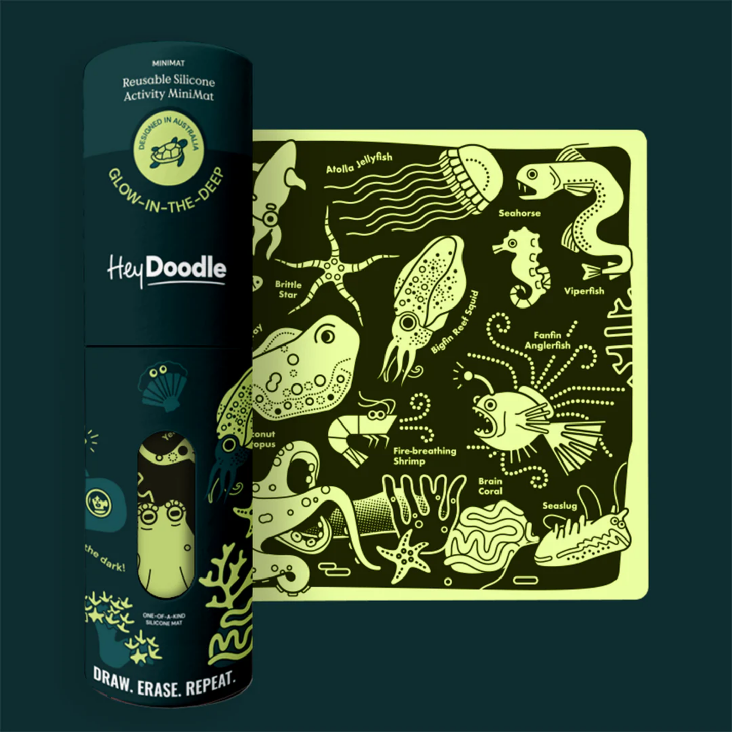 Shown glowing HeyDoodle Glow-in-the-Deep Mini Colouring & Doodle Mat - reusable silicone glow-in-the-dark travel mat with ocean creatures design, includes 3 non-toxic markers and pouch for mess-free creative fun on the go.