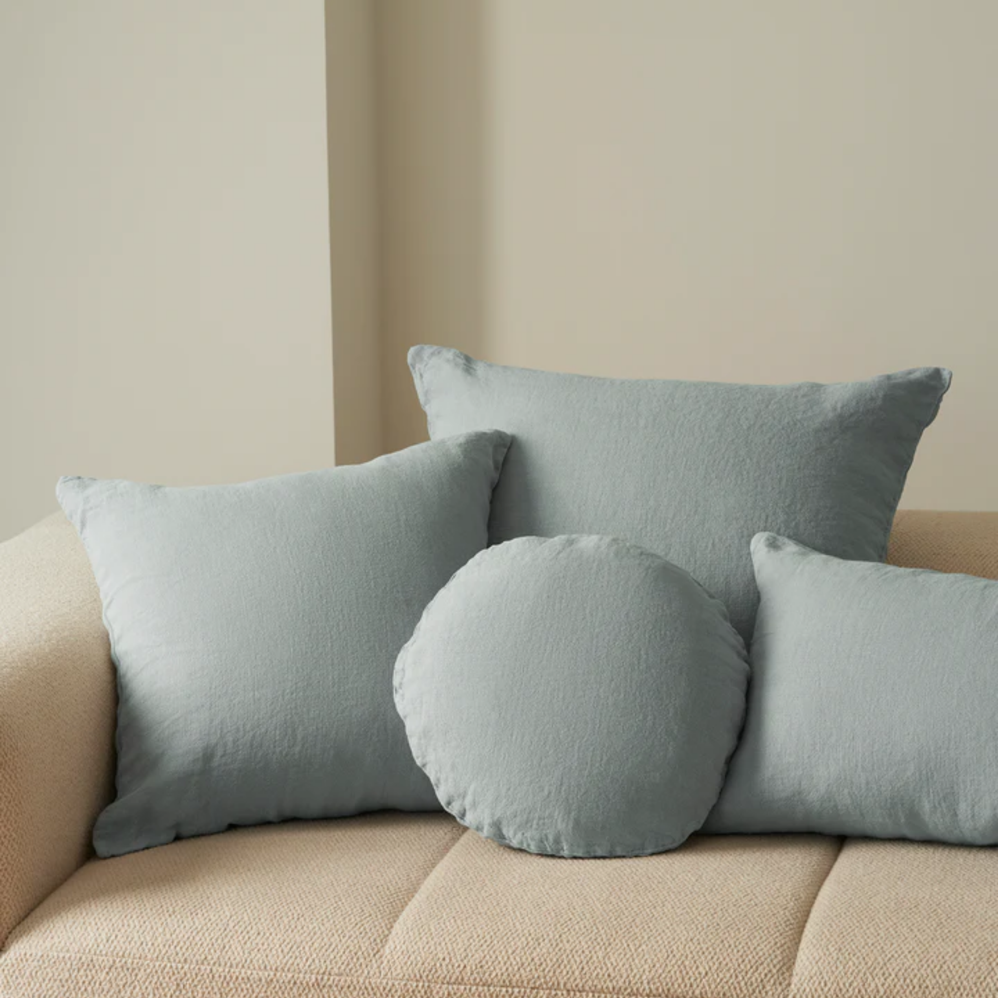 Hommey linen cushion sky on display on couch with linen sky range