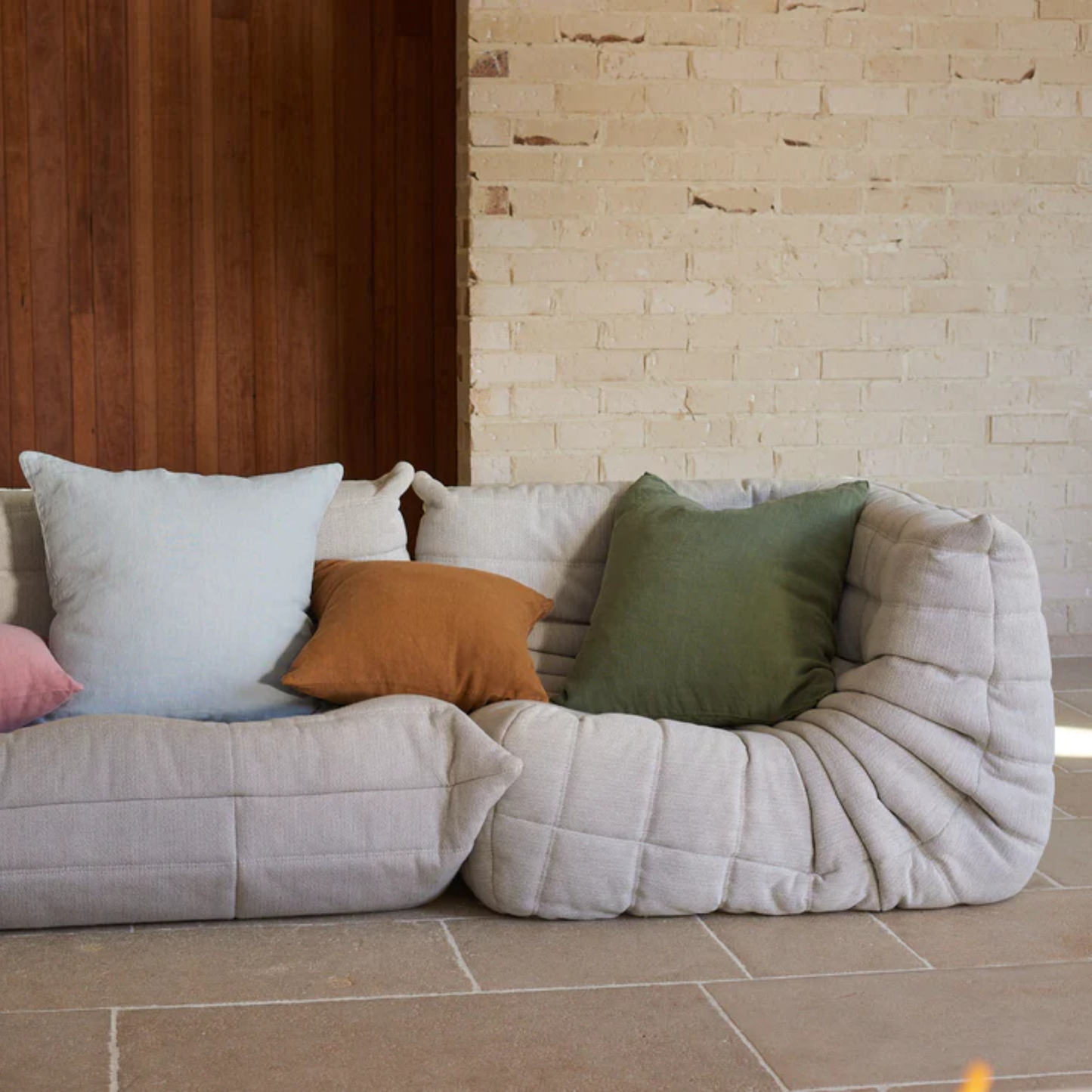 Hommey linen cushion moss on couch