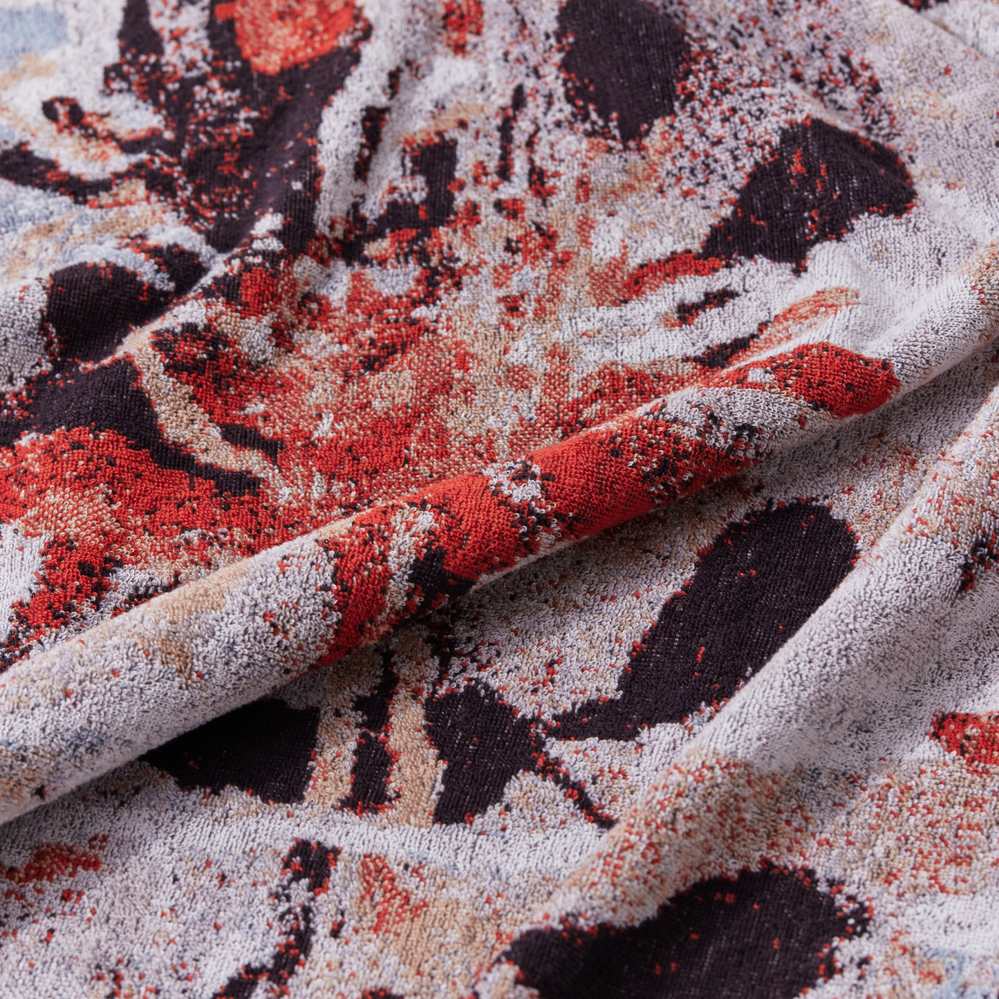 Close up view of the Innate Ilford bath sheet 100 x 150 cm, luxury oversized absorbent terry cotton bath sheet in multi-coloured Waratah jacquard design, thick and dense with intricate organic patterns, made from 100% OEKO-TEX certified cotton and responsibly woven in Portugal.
