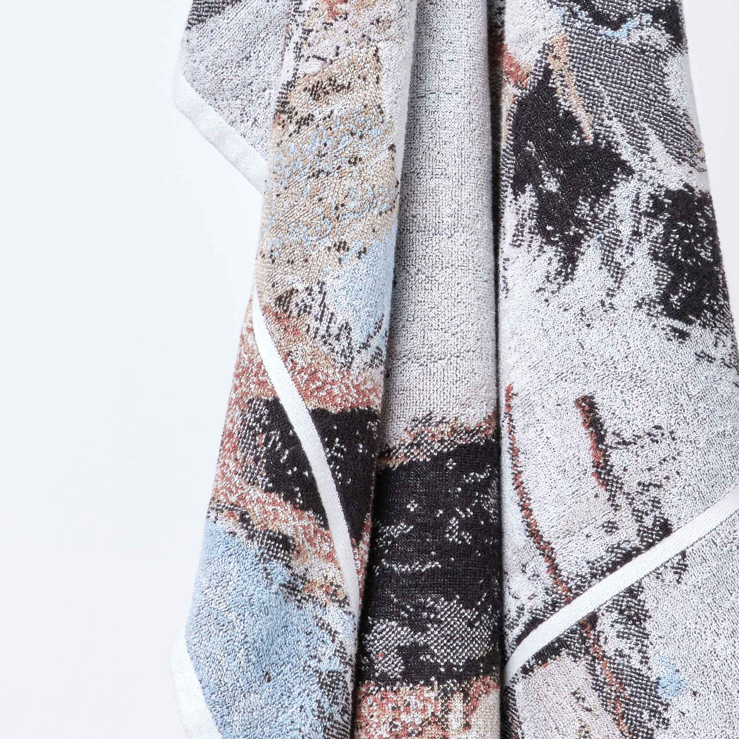 Another close up from a hung Innate NT Morning Bath Sheet 100cm x 150cm bath sheet in warm earthy tones inspired by Australia's Top End landscape, made from 100% OEKO-TEX® certified cotton, featuring an absorbent six-colour jacquard weave with rich texture and weight, responsibly woven in Portugal for everyday premium use.