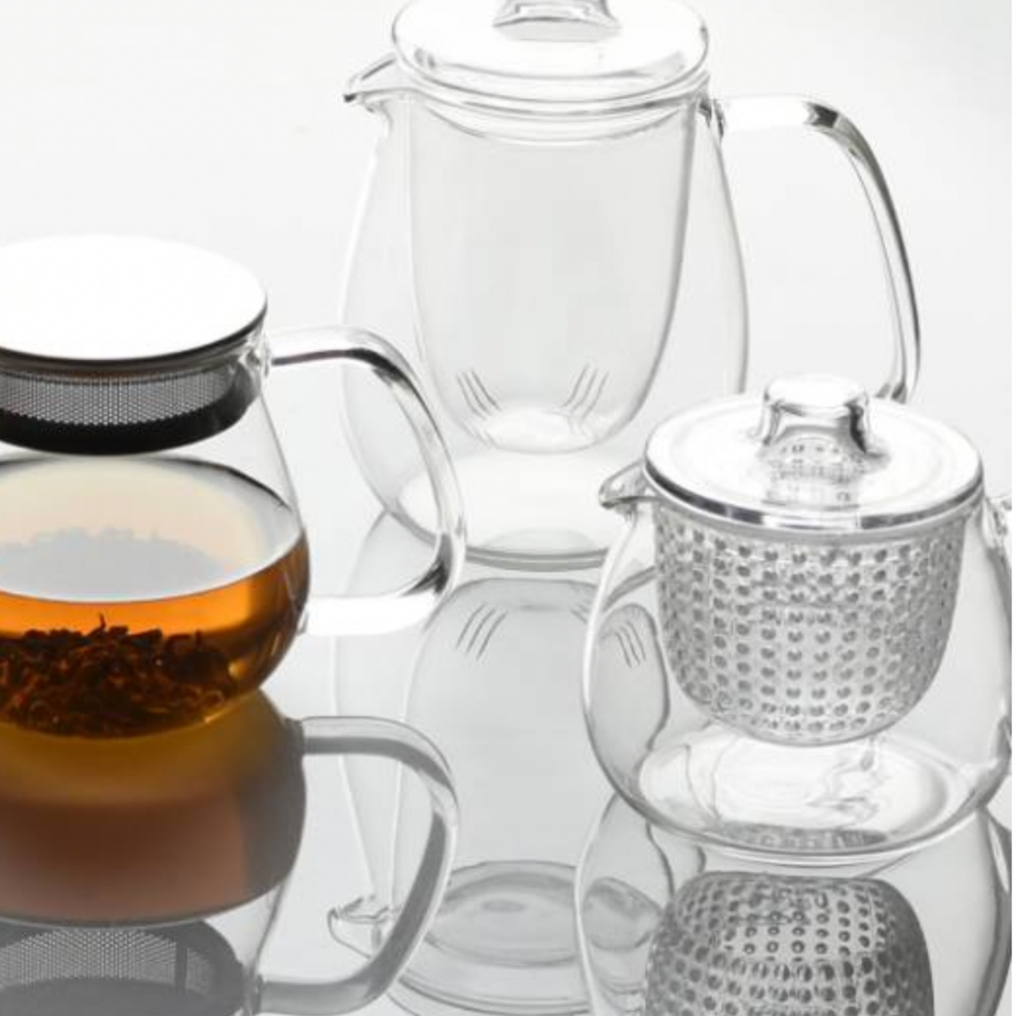 Stylish glass Kinto Unitea Unimug Clear 350ml on display with assorted Kinto glassware on mirrored table
