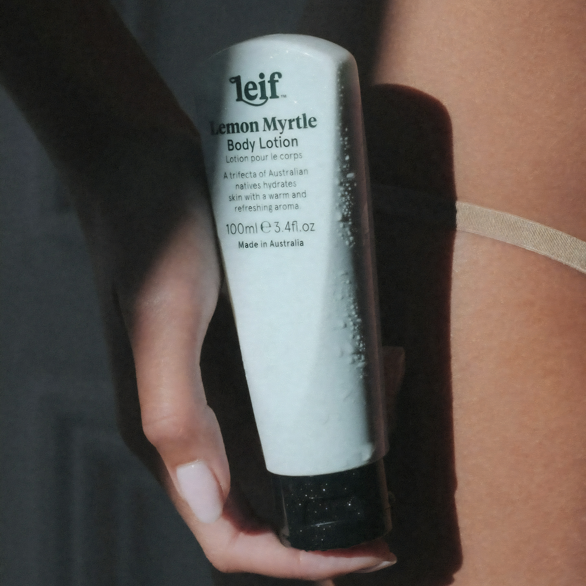 Close up on the Leif Body Lotion 100ml Lemon Myrtle, it is warm and herbaceous with sandalwood and eucalyptus, in a design fit for travel.