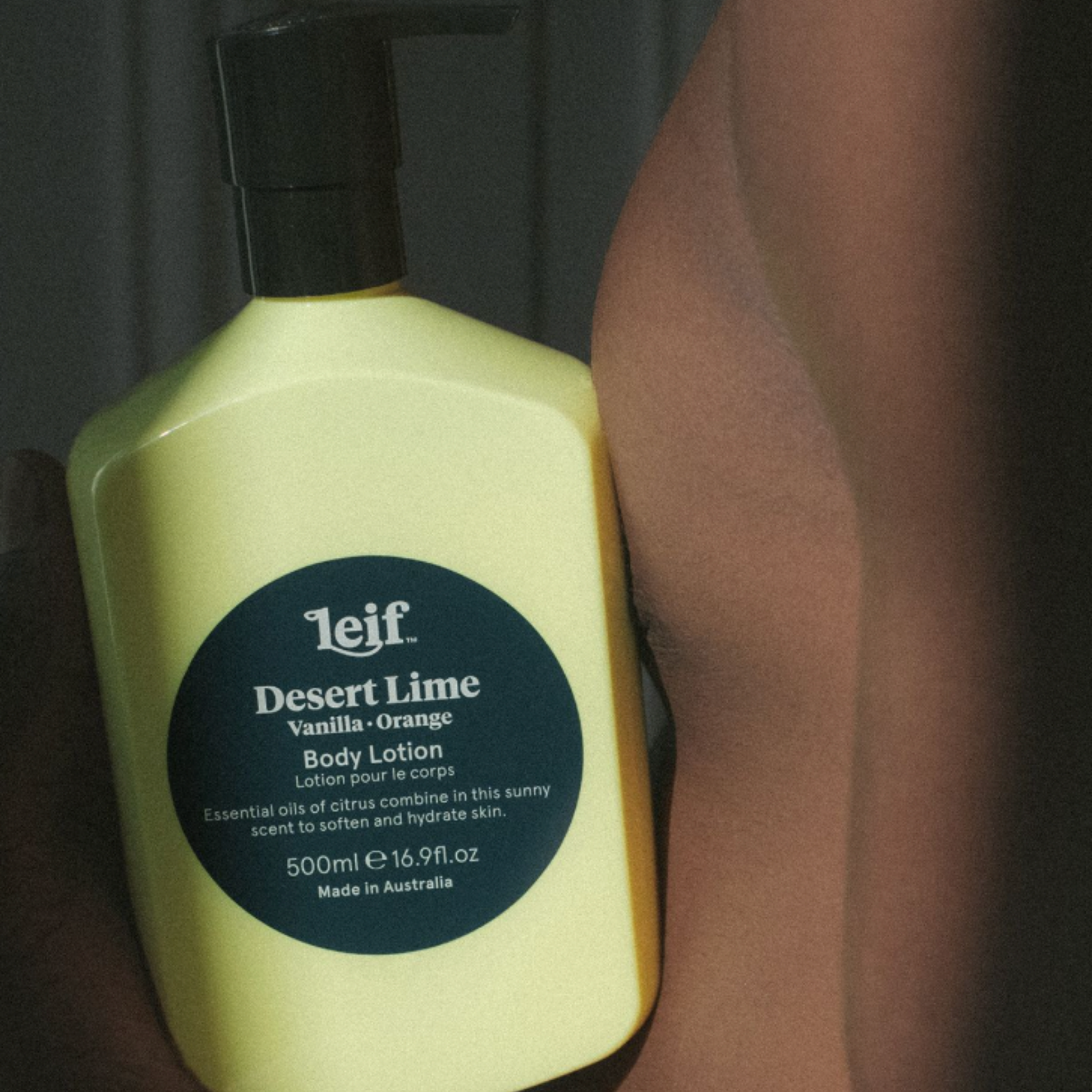 Leif body lotion Desert Lime 500ml balanced between mans chest and hand.