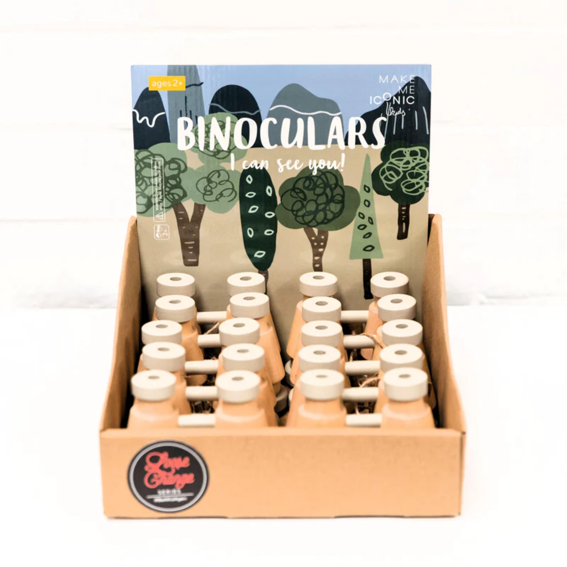 In a tray a group of Make Me Iconic wooden toy binoculars - natural solid wood binoculars designed for kids' imaginative play, featuring a smooth finish and easy-grip shape for little explorers.