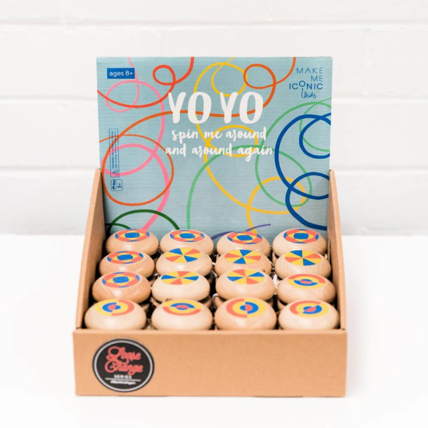 In a tray a group of Make Me Iconic wooden yo-yo toy - durable timber yo-yo with retro-style painted designs, crafted for smooth spinning and easy tricks, a nostalgic skill toy for kids and adults.