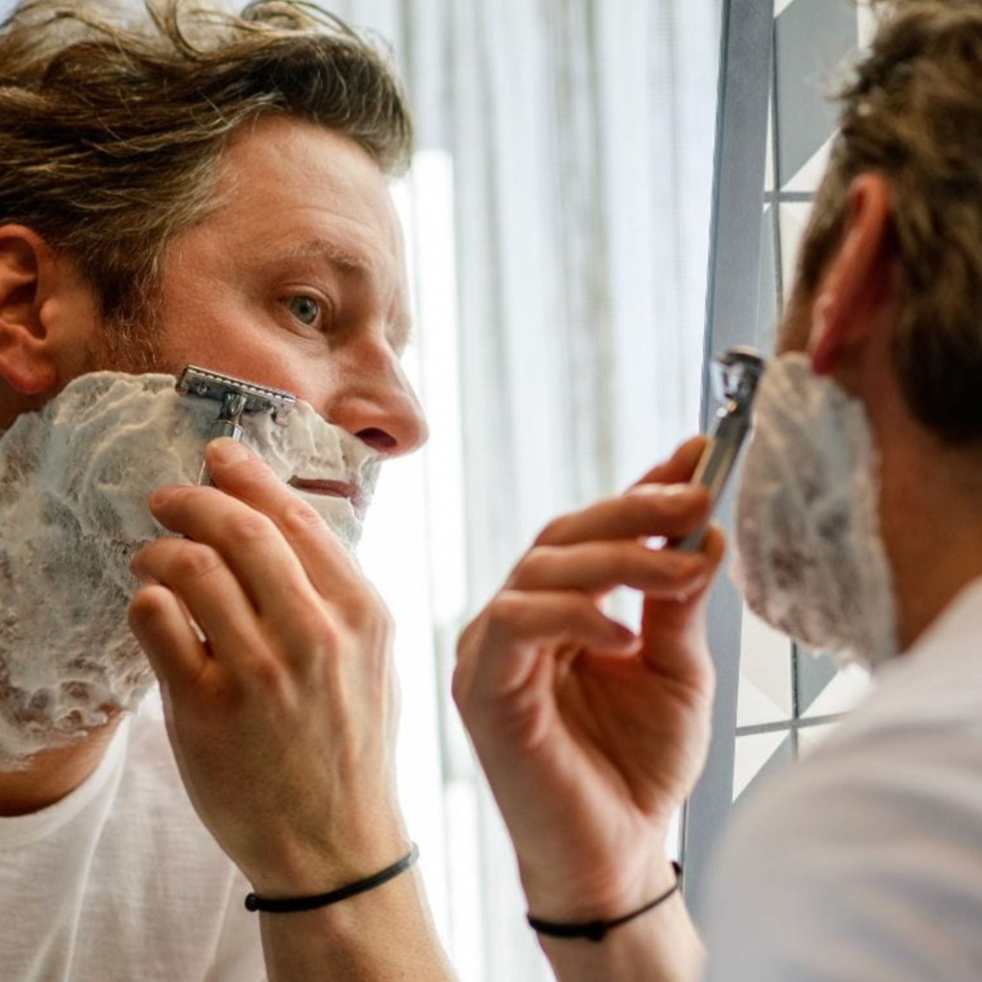 Man shaving beard in mirror with Stylish Merkur Safety Razor 34C Chrome 