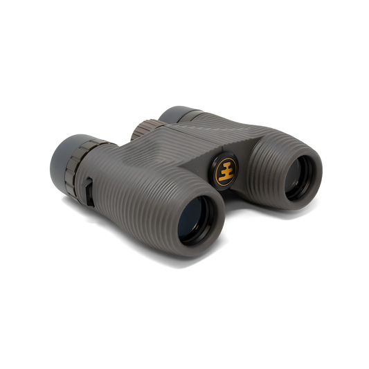 Semi side view of Nocs Provisions Binocular Standard Issue 8X25 Charcoal black that has multi-coated lenses and premium BaK4 prisms, waterproof, fogproof and compact.